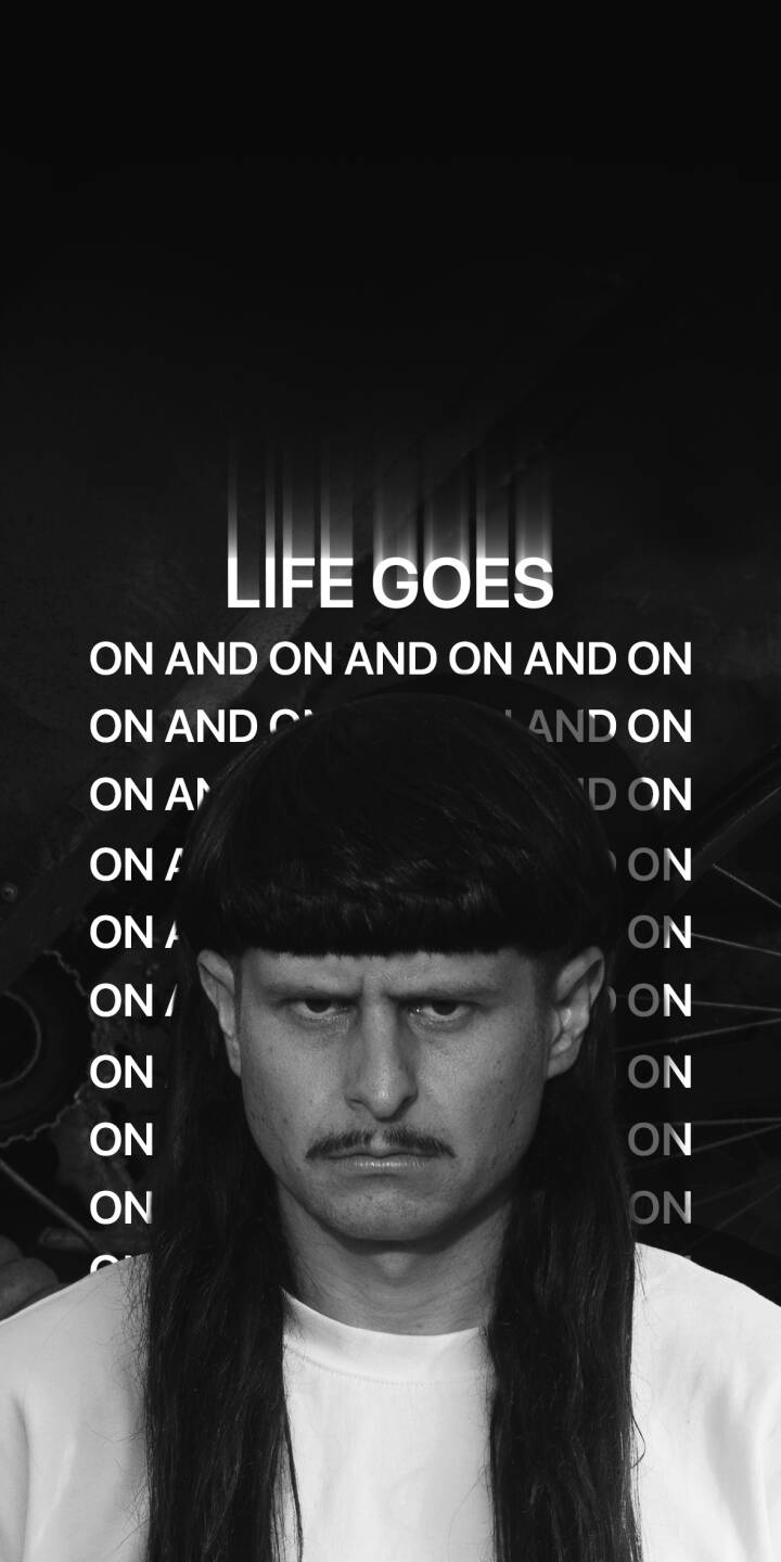 Oliver Tree's signature stern expression and iconic bowl cut are front and center in this striking black and white 4K wallpaper. With 'LIFE GOES ON' lyrics repeating in the background, it's an essential wallpaper for iPhone fans. | aesthetic man iphone wallpaper mobile 4k wallpaper hd wallpaper monochrome surreal intense dramatic life goes Oliver Tree's signature stern expression and iconic bowl cut are front and center in this striking black and white 4K wallpaper. With 'LIFE GOES ON' lyrics repeating in the background, it's an essential wallpaper for iPhone fans.