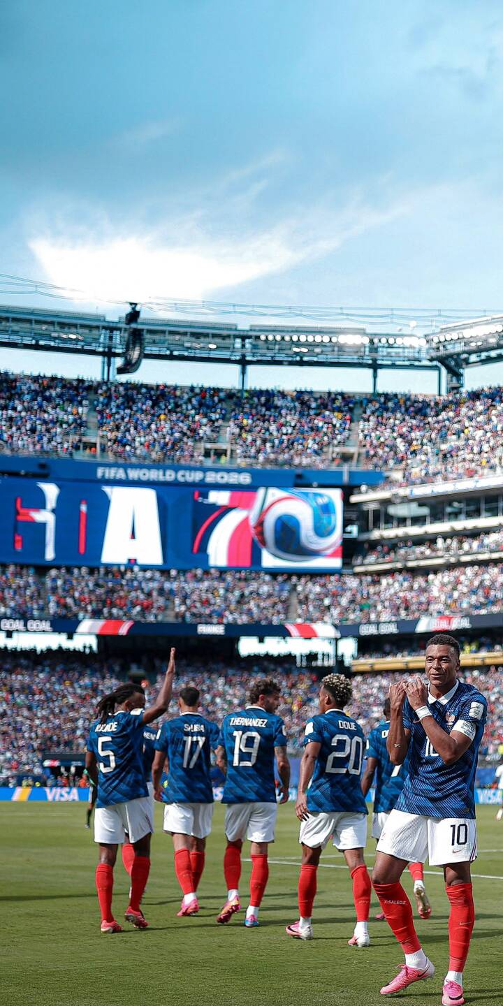 Kylian Mbappé claps proudly on the vibrant green pitch, surrounded by his French teammates and a massive stadium crowd, creating an epic 4K football wallpaper perfect for iPhone. | sports stadium iphone mbappe soccer wallpaper mobile 4k wallpaper hd wallpaper world cup france football kylian mbappe Kylian Mbappé claps proudly on the vibrant green pitch, surrounded by his French teammates and a massive stadium crowd, creating an epic 4K football wallpaper perfect for iPhone.