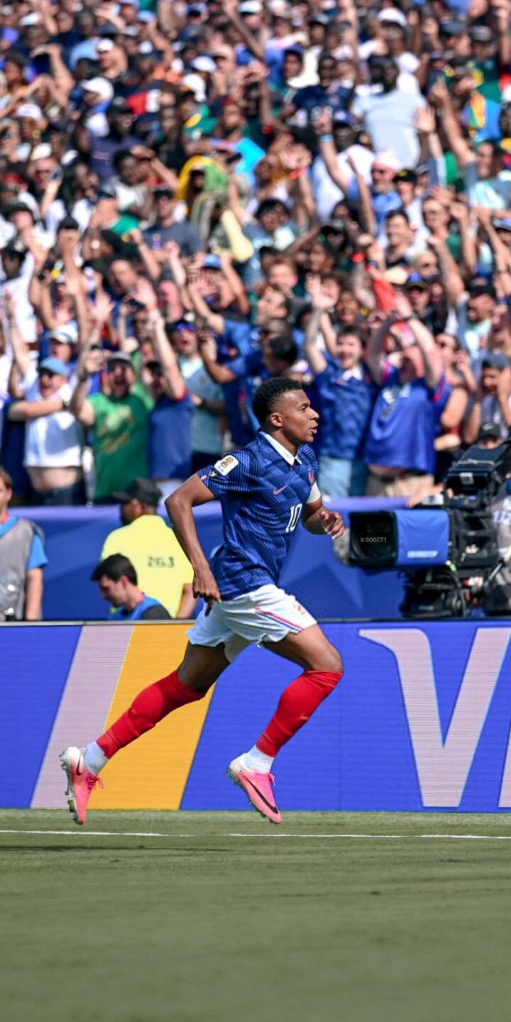 Kylian Mbappé sprints across the pitch in his blue France jersey and vibrant pink boots, eyes fixed on the goal amid a cheering crowd in this dynamic 4K wallpaper. This stunning football wallpaper is perfect for your iPhone, capturing the excitement of the game. | football stadium iphone france mbappe soccer wallpaper sport mobile 4k wallpaper hd wallpaper kylian mbappe Kylian Mbappé sprints across the pitch in his blue France jersey and vibrant pink boots, eyes fixed on the goal amid a cheering crowd in this dynamic 4K wallpaper. This stunning football wallpaper is perfect for your iPhone, capturing the excitement of the game.