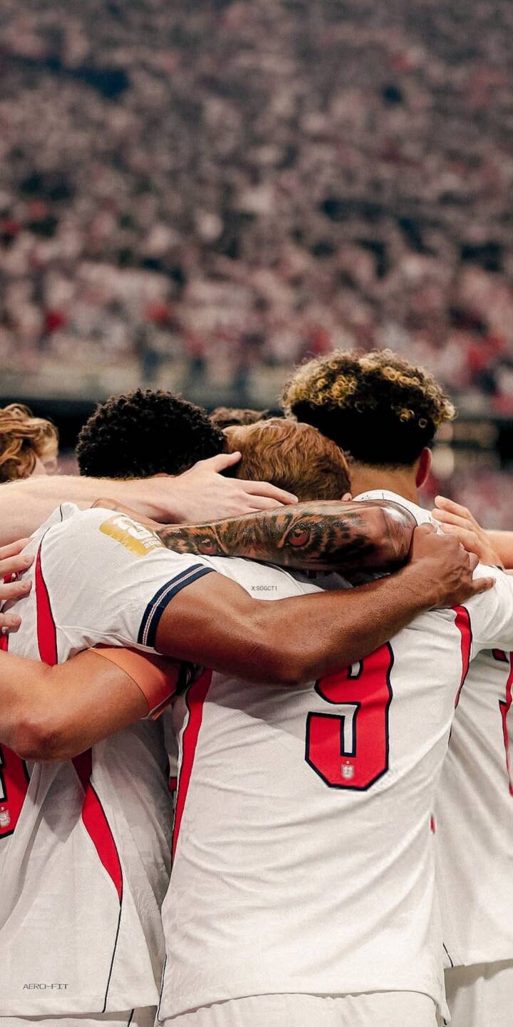 The unified England football squad shares a heartfelt embrace in this striking 4K wallpaper, capturing their team spirit amidst a blurred stadium crowd, perfect as an inspiring wallpaper for your iPhone. | sports football team celebration iphone soccer wallpaper mobile 4k wallpaper hd wallpaper unity england football team huddle The unified England football squad shares a heartfelt embrace in this striking 4K wallpaper, capturing their team spirit amidst a blurred stadium crowd, perfect as an inspiring wallpaper for your iPhone.