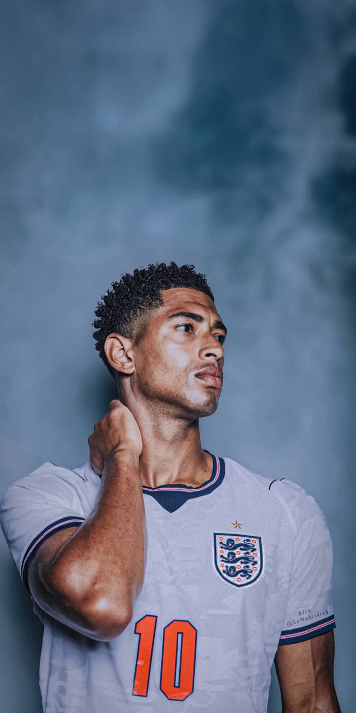 Jude Bellingham's intense side-profile gaze captures attention in this striking 4K football wallpaper. Featuring his thoughtful hand placement and England's number 10 jersey, it's an ideal wallpaper for any iPhone fan. | portrait athlete iphone real madrid wallpaper jude bellingham mobile 4k wallpaper hd wallpaper number 10 soccer star england football Jude Bellingham's intense side-profile gaze captures attention in this striking 4K football wallpaper. Featuring his thoughtful hand placement and England's number 10 jersey, it's an ideal wallpaper for any iPhone fan.