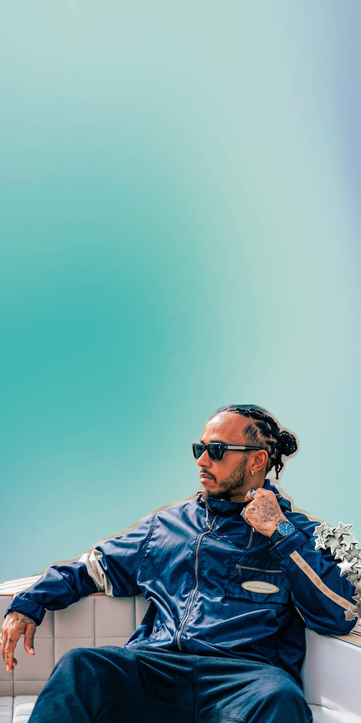 Lewis Hamilton's sleek sunglasses and vibrant blue tracksuit pop against an aqua gradient background in this dynamic 4K wallpaper. A perfect wallpaper for iPhone users, capturing the essence of the racing icon. | sunglasses iphone wallpaper f1 aqua lewis hamilton formula 1 mobile celebrity 4k wallpaper hd wallpaper tracksuit Lewis Hamilton's sleek sunglasses and vibrant blue tracksuit pop against an aqua gradient background in this dynamic 4K wallpaper. A perfect wallpaper for iPhone users, capturing the essence of the racing icon.
