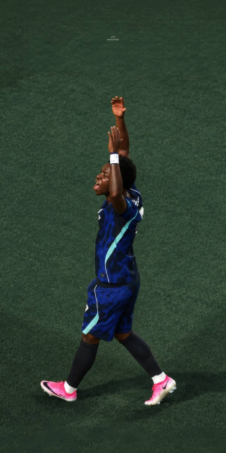 Vibrant pink football boots stand out as this player raises arms high in a moment of triumph on the green pitch, making for a compelling 4K wallpaper — a perfect mobile wallpaper for iPhone soccer fans. | sports player athlete celebration iphone soccer wallpaper mobile footballer 4k wallpaper hd wallpaper pink boots Vibrant pink football boots stand out as this player raises arms high in a moment of triumph on the green pitch, making for a compelling 4K wallpaper — a perfect mobile wallpaper for iPhone soccer fans.