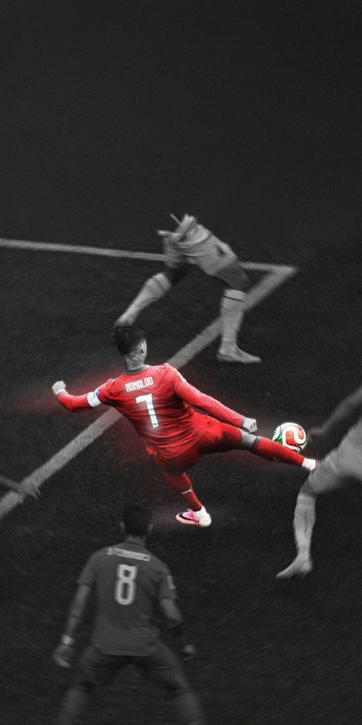 Cristiano Ronaldo's iconic red kit and a colorful football brilliantly pop against a desaturated, dark pitch in this stunning 4K wallpaper. This dynamic wallpaper, capturing Ronaldo in mid-kick, is perfect for any iPhone to showcase his athletic prowess. | sports football dark iphone soccer wallpaper cr7 cristiano ronaldo mobile 4k wallpaper hd wallpaper energetic Cristiano Ronaldo's iconic red kit and a colorful football brilliantly pop against a desaturated, dark pitch in this stunning 4K wallpaper. This dynamic wallpaper, capturing Ronaldo in mid-kick, is perfect for any iPhone to showcase his athletic prowess.
