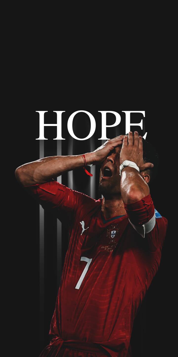 Sweat drips down the face of a soccer player clutching his head in this dramatic 4K wallpaper, featuring the prominent white text 'HOPE' against a dark background, making it an impactful wallpaper for iPhone users. | football athlete iphone minimalist soccer wallpaper mobile 4k wallpaper hd wallpaper emotion red jersey hope Sweat drips down the face of a soccer player clutching his head in this dramatic 4K wallpaper, featuring the prominent white text 'HOPE' against a dark background, making it an impactful wallpaper for iPhone users.