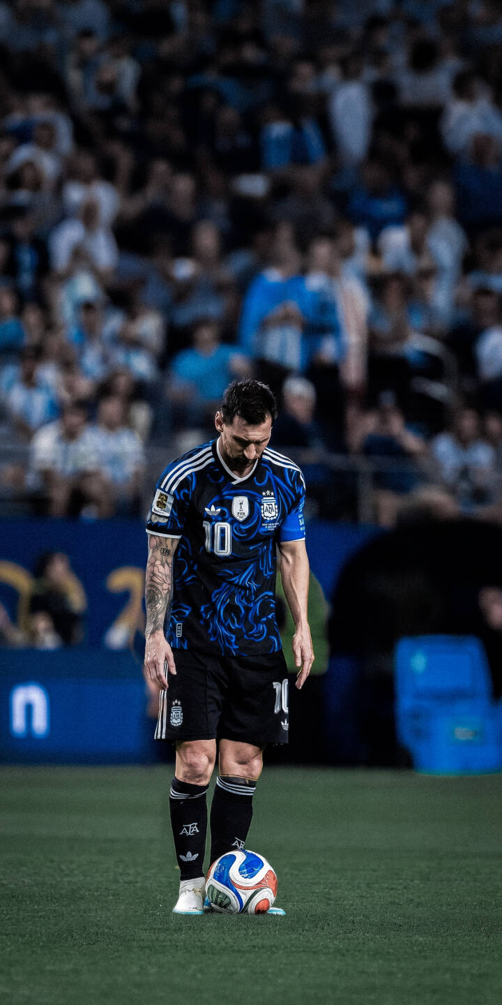 Lionel Messi stands intently over the soccer ball, clad in his distinctive dark blue and light blue patterned number 10 jersey in this stunning 4K wallpaper for iPhone. This premium wallpaper captures the focused intensity of the legendary footballer, perfect for any fan's mobile background. | football iphone messi argentina soccer wallpaper sport lionel messi mobile 4k wallpaper hd wallpaper dark jersey Lionel Messi stands intently over the soccer ball, clad in his distinctive dark blue and light blue patterned number 10 jersey in this stunning 4K wallpaper for iPhone. This premium wallpaper captures the focused intensity of the legendary footballer, perfect for any fan's mobile background.