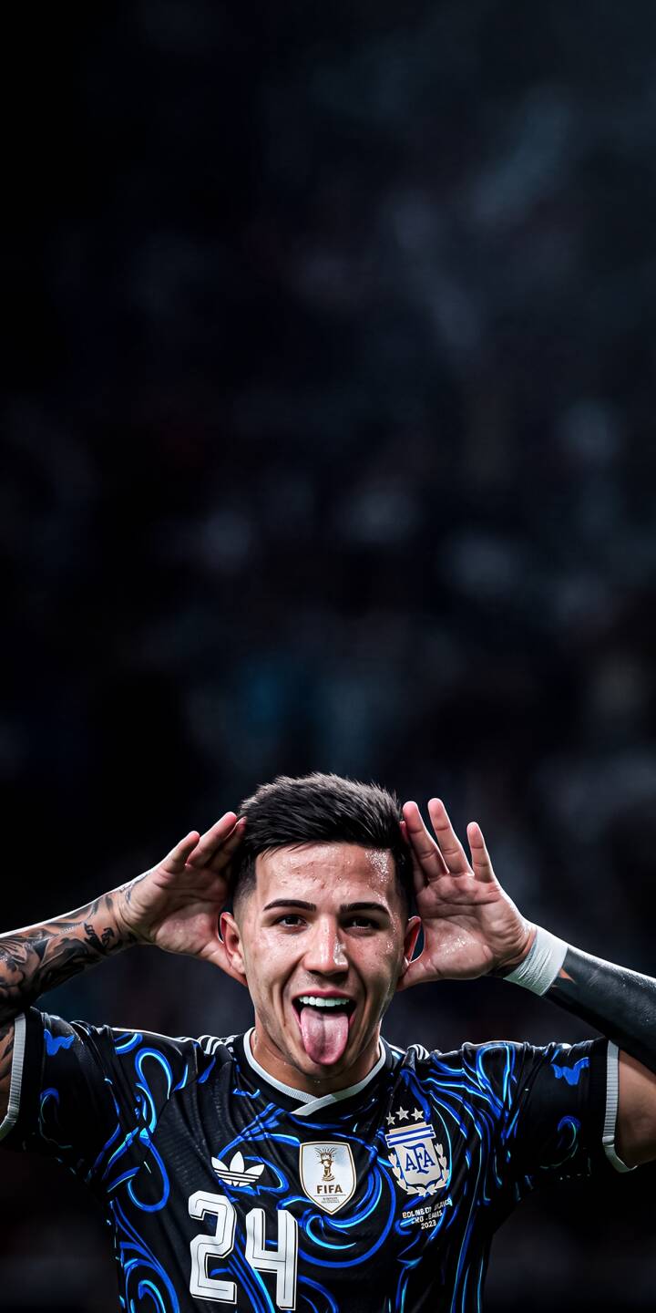 Enzo Fernández playfully sticks out his tongue with hands by his head, celebrating in his distinctive blue and black Argentina jersey, making for a vibrant 4K wallpaper. This dynamic football wallpaper is a perfect fit for any iPhone, capturing the star's charismatic energy. | football celebration iphone argentina soccer wallpaper mobile 4k wallpaper hd wallpaper playful enzo fernandez enzo fernández Enzo Fernández playfully sticks out his tongue with hands by his head, celebrating in his distinctive blue and black Argentina jersey, making for a vibrant 4K wallpaper. This dynamic football wallpaper is a perfect fit for any iPhone, capturing the star's charismatic energy.