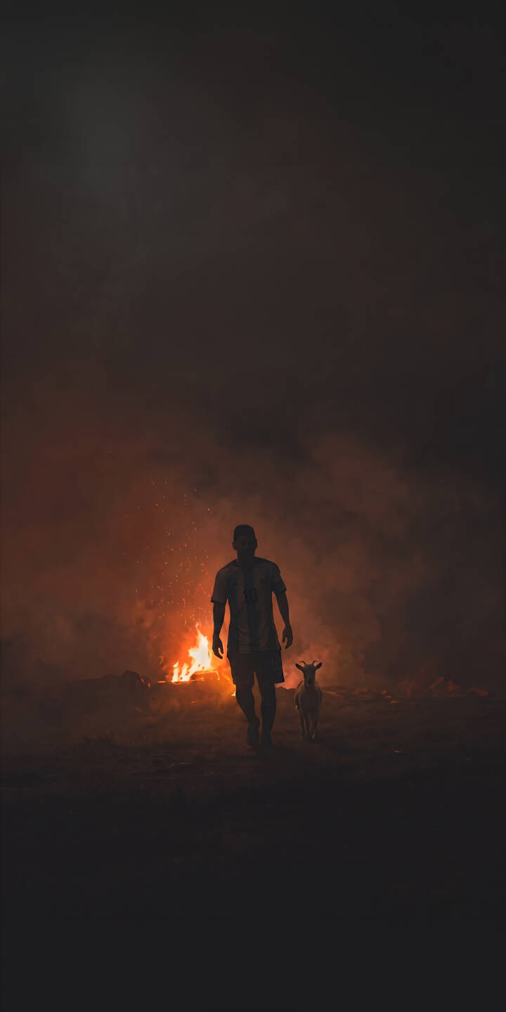 A blazing inferno lights up the dark background as a silhouetted figure, often hailed as the GOAT, stands stoically beside a small goat companion in this intense 4K wallpaper. This captivating wallpaper is a must-have for iPhone users seeking a powerful and mysterious scene with its fiery glow. | man dark fire iphone wallpaper goat silhouette mobile 4k wallpaper hd wallpaper dramatic A blazing inferno lights up the dark background as a silhouetted figure, often hailed as the GOAT, stands stoically beside a small goat companion in this intense 4K wallpaper. This captivating wallpaper is a must-have for iPhone users seeking a powerful and mysterious scene with its fiery glow.