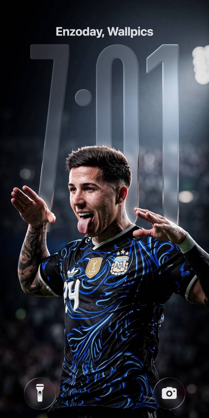 Enzo Fernandez playfully sticks out his tongue with hands raised in celebration, showcasing his striking blue swirl Argentina jersey in this dynamic 4K wallpaper. This spirited moment is an ideal wallpaper for iPhone users who love football. | sports football celebration iphone argentina soccer wallpaper mobile 4k wallpaper hd wallpaper playful enzo fernandez Enzo Fernandez playfully sticks out his tongue with hands raised in celebration, showcasing his striking blue swirl Argentina jersey in this dynamic 4K wallpaper. This spirited moment is an ideal wallpaper for iPhone users who love football.