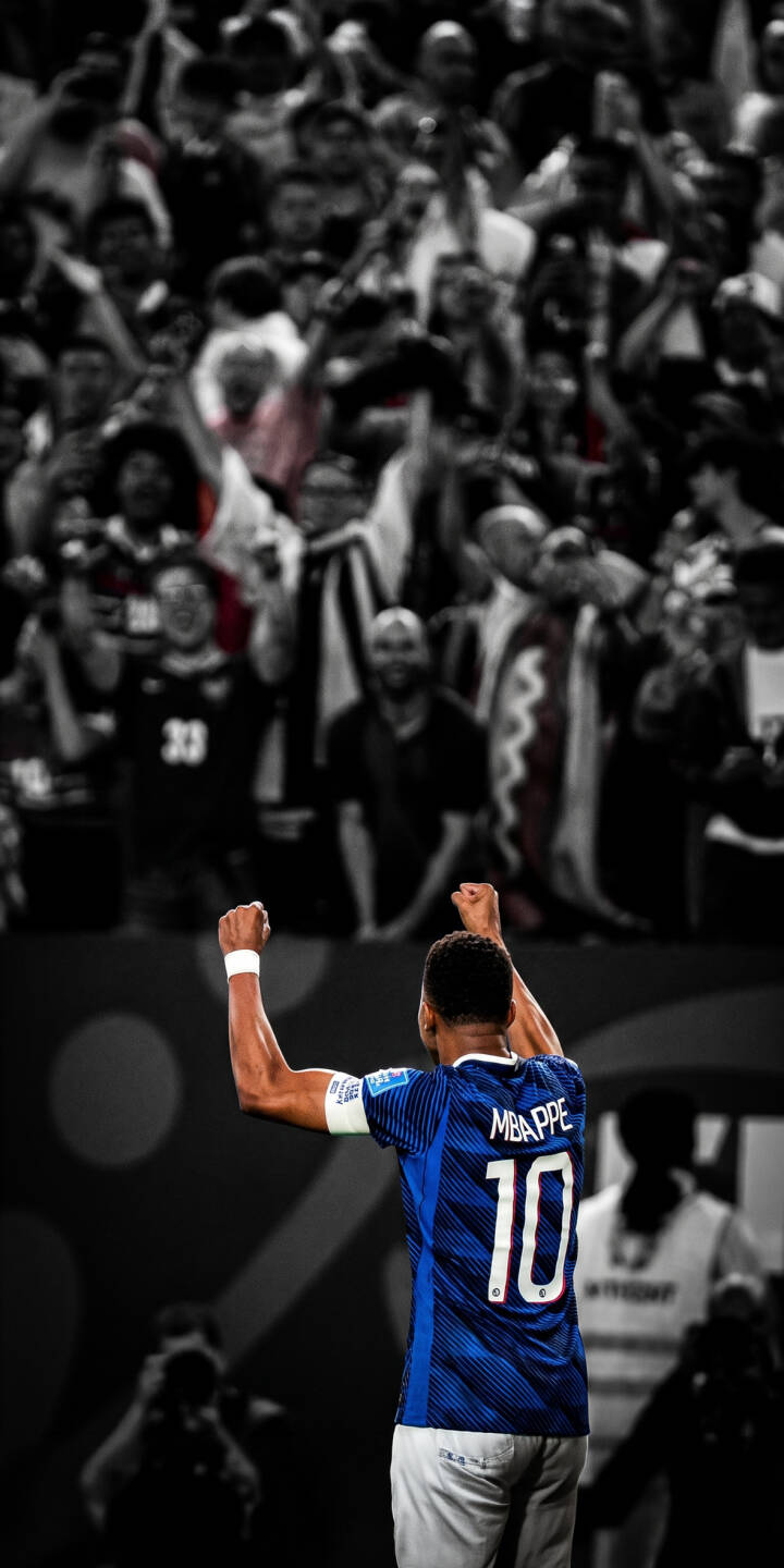 Kylian Mbappé's vibrant blue jersey and powerful celebratory pose dominate this striking 4K wallpaper, set against a desaturated, roaring crowd; it's an essential sports wallpaper for your iPhone. | sports football celebration iphone france mbappe soccer wallpaper mobile 4k wallpaper hd wallpaper kylian mbappe Kylian Mbappé's vibrant blue jersey and powerful celebratory pose dominate this striking 4K wallpaper, set against a desaturated, roaring crowd; it's an essential sports wallpaper for your iPhone.