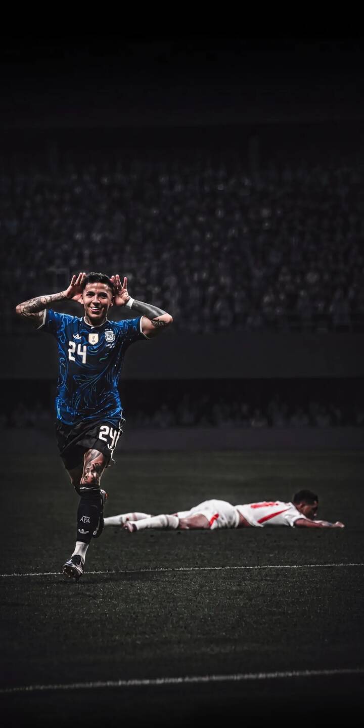 Enzo Fernández's beaming smile and celebratory gesture after a goal create an electrifying moment in this 4K wallpaper, featuring his iconic Argentina blue jersey and an opponent fallen on the pitch, perfect as an iPhone wallpaper for football fans. | sports football stadium celebration iphone argentina soccer wallpaper mobile 4k wallpaper hd wallpaper enzo fernández Enzo Fernández's beaming smile and celebratory gesture after a goal create an electrifying moment in this 4K wallpaper, featuring his iconic Argentina blue jersey and an opponent fallen on the pitch, perfect as an iPhone wallpaper for football fans.