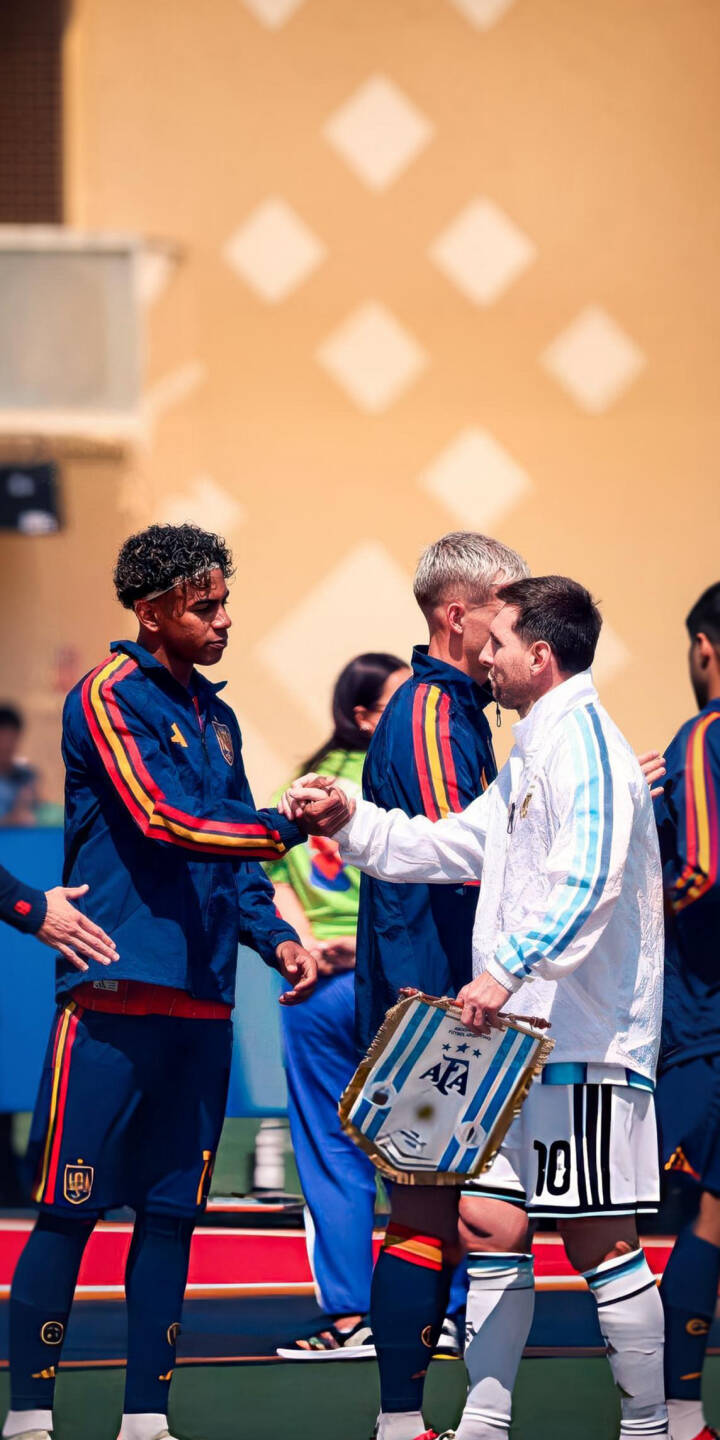 Lionel Messi, dressed in his iconic white and light blue Argentina kit, is captured mid-handshake with a player in a vibrant Spain jersey in this compelling 4K wallpaper, making it an essential wallpaper for iPhone fans of football legends. | sports football iphone messi argentina spain wallpaper lamine yamal lionel messi mobile handshake 4k wallpaper hd wallpaper Lionel Messi, dressed in his iconic white and light blue Argentina kit, is captured mid-handshake with a player in a vibrant Spain jersey in this compelling 4K wallpaper, making it an essential wallpaper for iPhone fans of football legends.