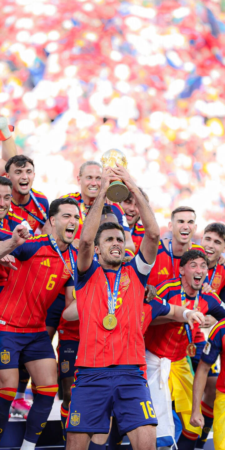 The victorious Spanish football team jubilantly hoists the World Cup trophy high as colorful confetti rains down in this celebratory 4K wallpaper — an essential iPhone wallpaper for any fan. | football trophy celebration iphone soccer spain wallpaper champions mobile 4k wallpaper hd wallpaper world cup The victorious Spanish football team jubilantly hoists the World Cup trophy high as colorful confetti rains down in this celebratory 4K wallpaper — an essential iPhone wallpaper for any fan.