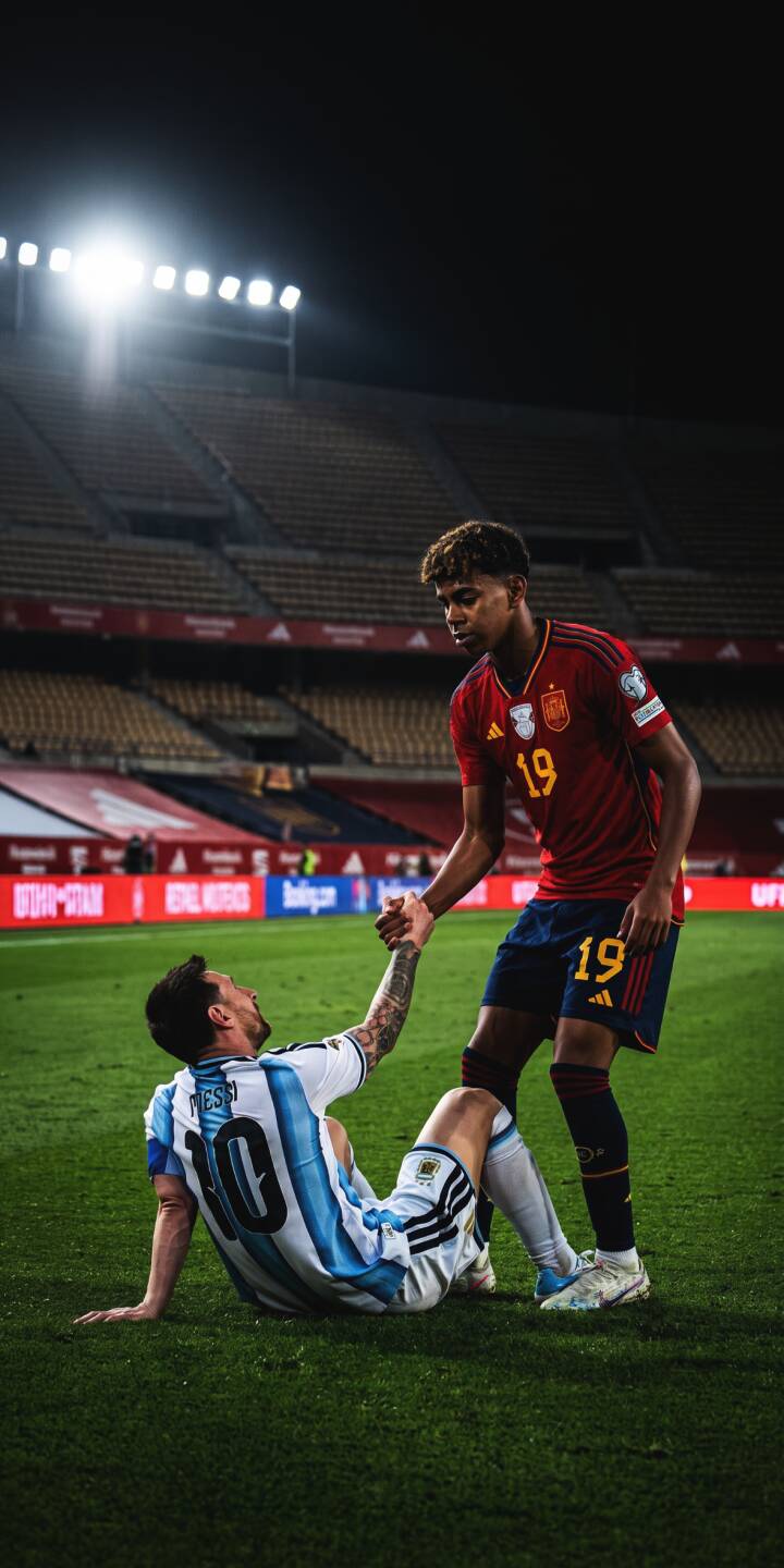 Lamine Yamal extends a hand to help a seated Messi up from the pitch, capturing a moment of sportsmanship in this striking 4K football wallpaper for iPhone. This iconic handshake makes for a legendary wallpaper. | football player iphone messi soccer wallpaper lamine yamal mobile 4k wallpaper hd wallpaper gavi stadium lights sportsmanship Lamine Yamal extends a hand to help a seated Messi up from the pitch, capturing a moment of sportsmanship in this striking 4K football wallpaper for iPhone. This iconic handshake makes for a legendary wallpaper.