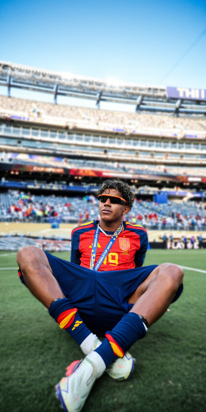 Orange sunglasses shield the eyes of this triumphant Spanish footballer, wearing a number 10 jersey and a FIFA World Cup medal, as he relaxes on the stadium turf in this vibrant 4K wallpaper. This exclusive wallpaper captures a unique moment of athletic pride, making it an excellent choice for your iPhone background. | football stadium athlete iphone spain wallpaper soccer player jersey sport mobile 4k wallpaper hd wallpaper Orange sunglasses shield the eyes of this triumphant Spanish footballer, wearing a number 10 jersey and a FIFA World Cup medal, as he relaxes on the stadium turf in this vibrant 4K wallpaper. This exclusive wallpaper captures a unique moment of athletic pride, making it an excellent choice for your iPhone background.