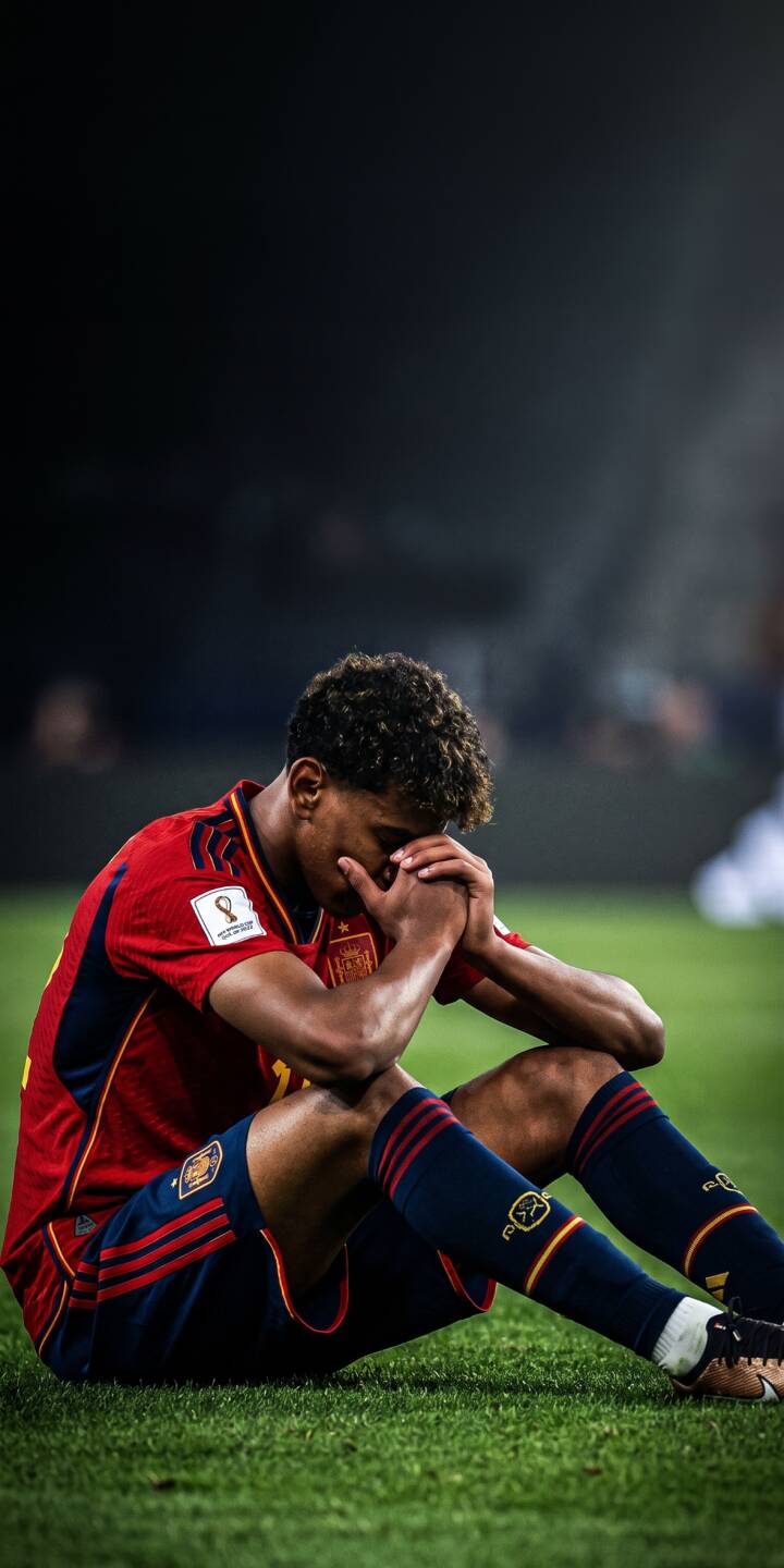 Lamine Yamal sits dejectedly on the vibrant green pitch, his hands clasped and head bowed in this striking 4K wallpaper, capturing a poignant moment in his Spain national team jersey. This emotional scene makes a powerful iPhone wallpaper for fans. | iphone wallpaper sad mobile emotional footballer 4k wallpaper hd wallpaper world cup spain football lamine yamal wallpaper Lamine Yamal sits dejectedly on the vibrant green pitch, his hands clasped and head bowed in this striking 4K wallpaper, capturing a poignant moment in his Spain national team jersey. This emotional scene makes a powerful iPhone wallpaper for fans.