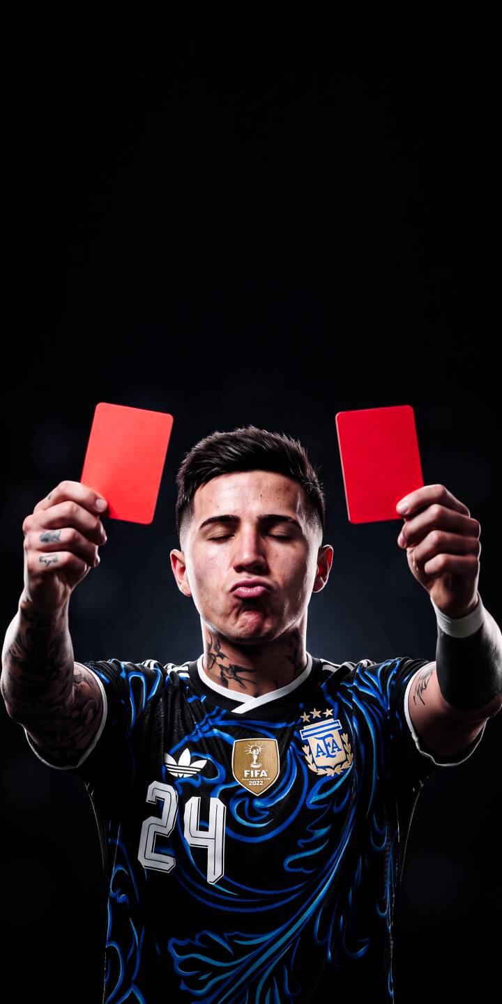 Puckering his lips with eyes closed, Enzo Fernández playfully holds up two bright red cards in this striking 4K wallpaper for fans. This unique wallpaper perfectly captures the soccer star's personality, making it an excellent choice for your iPhone. | sports football player iphone argentina soccer wallpaper red card mobile 4k wallpaper hd wallpaper enzo fernandez Puckering his lips with eyes closed, Enzo Fernández playfully holds up two bright red cards in this striking 4K wallpaper for fans. This unique wallpaper perfectly captures the soccer star's personality, making it an excellent choice for your iPhone.