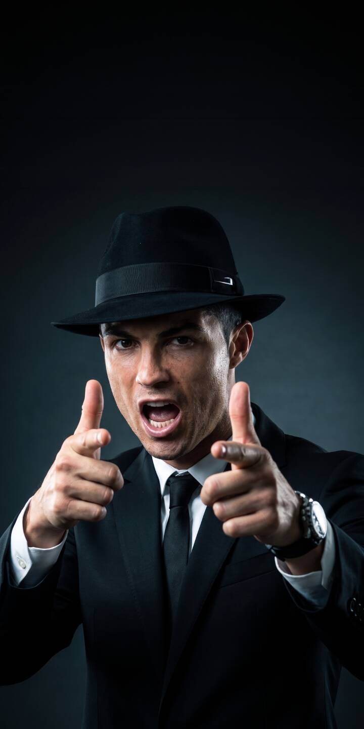 Cristiano Ronaldo commands attention, wearing a sharp black suit and a stylish fedora, pointing directly at the viewer with an intense expression in this striking 4K wallpaper. This captivating wallpaper is perfect for any iPhone. | suit iphone ronaldo wallpaper cr7 cristiano ronaldo mobile 4k wallpaper hd wallpaper fedora intense gangster style Cristiano Ronaldo commands attention, wearing a sharp black suit and a stylish fedora, pointing directly at the viewer with an intense expression in this striking 4K wallpaper. This captivating wallpaper is perfect for any iPhone.