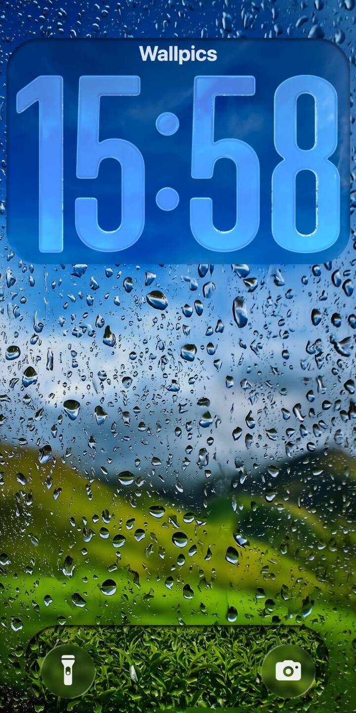 Thousands of glistening raindrops cling to a window, beautifully distorting the blurred green landscape and clear blue sky behind them in this stunning 4K wallpaper; a perfect rain aesthetic wallpaper for iPhone. | aesthetic landscape window rain iphone nature wallpaper vibrant mobile 4k wallpaper hd wallpaper raindrops Thousands of glistening raindrops cling to a window, beautifully distorting the blurred green landscape and clear blue sky behind them in this stunning 4K wallpaper; a perfect rain aesthetic wallpaper for iPhone.
