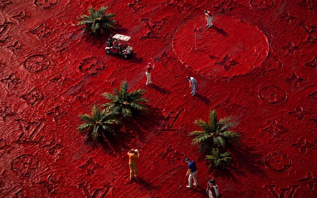 A surreal, vibrant red golf course, emblazoned with textured Louis Vuitton monograms and miniature golfers, makes for an opulent 4K desktop wallpaper. This artistic and playful wallpaper, perfect for your MacOS or MacBook, showcases tiny palm trees and a golf cart amidst the luxurious crimson landscape. | red miniature golf luxury wallpaper macos louis vuitton 4k wallpaper hd wallpaper surreal macbook imac A surreal, vibrant red golf course, emblazoned with textured Louis Vuitton monograms and miniature golfers, makes for an opulent 4K desktop wallpaper. This artistic and playful wallpaper, perfect for your MacOS or MacBook, showcases tiny palm trees and a golf cart amidst the luxurious crimson landscape.