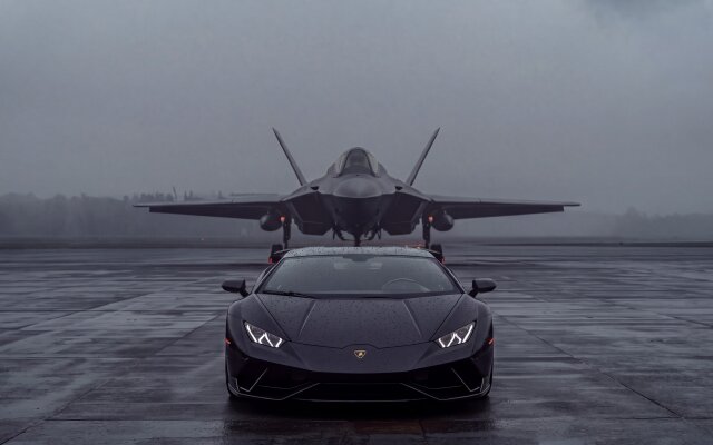 The powerful black Lamborghini Huracán, with its bright headlights, dominates the foreground on a wet tarmac, mirrored by a formidable stealth jet in the hazy background. This stunning 4K wallpaper captures an epic, moody scene perfect for your MacOS MacBook wallpaper, bringing sleek power to your desktop. | black car sports car jet rainy fighter jet grey luxury supercar wallpaper macos futuristic power lamborghini huracan moody 4k wallpaper hd wallpaper automotive dark aesthetic aviation jet plane runway stealth jet macbook imac f22 raptor airfield wet tarmac The powerful black Lamborghini Huracán, with its bright headlights, dominates the foreground on a wet tarmac, mirrored by a formidable stealth jet in the hazy background. This stunning 4K wallpaper captures an epic, moody scene perfect for your MacOS MacBook wallpaper, bringing sleek power to your desktop.