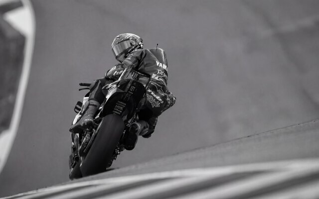 A motorcyclist powerfully leans into a turn on a racetrack, captured in stunning black and white for this dynamic 4K wallpaper. This intense racing action, featuring visible sponsor logos and a blurred background for speed, makes a compelling MacOS or MacBook wallpaper. | motorcycle dynamic wallpaper racing racer macos speed motogp 4k wallpaper hd wallpaper monochrome macbook A motorcyclist powerfully leans into a turn on a racetrack, captured in stunning black and white for this dynamic 4K wallpaper. This intense racing action, featuring visible sponsor logos and a blurred background for speed, makes a compelling MacOS or MacBook wallpaper.