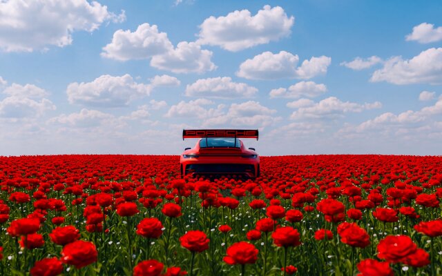 A vibrant red Porsche, seen from the rear with its distinctive spoiler, stands majestically amidst an expansive field of brilliant red flowers under a clear blue sky. This stunning 4K wallpaper captures the car's luxurious aesthetic against a natural, picturesque backdrop, making it a perfect MacOS wallpaper for automotive enthusiasts. | sports car porsche wallpaper vibrant macos red car 4k wallpaper hd wallpaper automotive macbook imac poppy field A vibrant red Porsche, seen from the rear with its distinctive spoiler, stands majestically amidst an expansive field of brilliant red flowers under a clear blue sky. This stunning 4K wallpaper captures the car's luxurious aesthetic against a natural, picturesque backdrop, making it a perfect MacOS wallpaper for automotive enthusiasts.