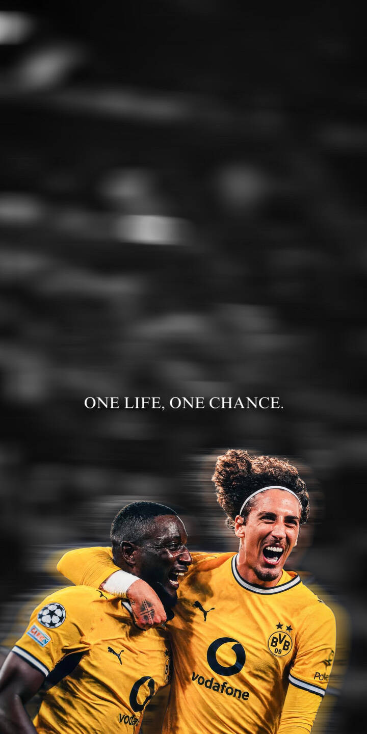 The inspiring quote 'ONE LIFE, ONE CHANCE' overlays two jubilant Borussia Dortmund players, Karim Adeyemi and Emre Can, embracing in their iconic yellow jerseys, creating a powerful 4K wallpaper for iPhone. This motivational wallpaper perfectly captures team spirit and an unmissable moment of joy. | football celebration iphone soccer wallpaper mobile 4k wallpaper hd wallpaper borussia dortmund bvb adeyemi emre can The inspiring quote 'ONE LIFE, ONE CHANCE' overlays two jubilant Borussia Dortmund players, Karim Adeyemi and Emre Can, embracing in their iconic yellow jerseys, creating a powerful 4K wallpaper for iPhone. This motivational wallpaper perfectly captures team spirit and an unmissable moment of joy.