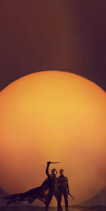 A colossal orange sun sets behind Paul Atreides raising his crysknife heroically alongside Chani, creating an epic 4K Dune wallpaper perfect for your iPhone. This dramatic desert wallpaper captures the raw beauty and danger of Arrakis. | dune A colossal orange sun sets behind Paul Atreides raising his crysknife heroically alongside Chani, creating an epic 4K Dune wallpaper perfect for your iPhone. This dramatic desert wallpaper captures the raw beauty and danger of Arrakis.