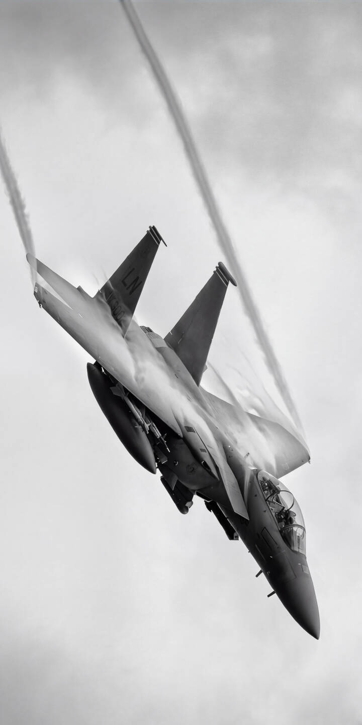 White contrails stream gracefully from the F-15 Eagle as it executes a sharp turn against a cloudy sky in this dramatic 4K wallpaper. This stunning jet wallpaper is perfect for any iPhone. | jet iphone fighter jet wallpaper mobile 4k wallpaper hd wallpaper monochrome aviation contrails f15 eagle White contrails stream gracefully from the F-15 Eagle as it executes a sharp turn against a cloudy sky in this dramatic 4K wallpaper. This stunning jet wallpaper is perfect for any iPhone.