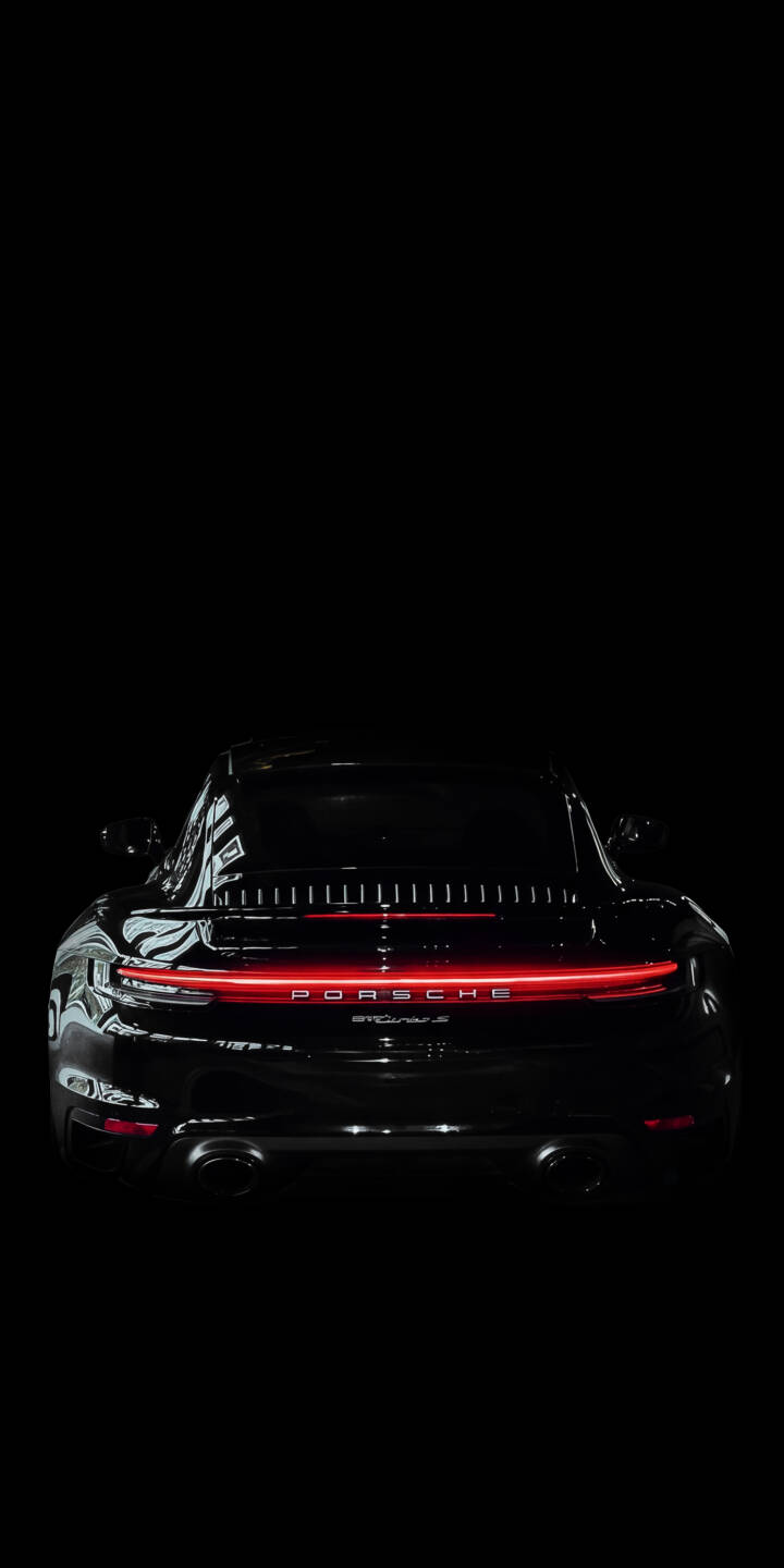 The vibrant red LED taillight strip glows brilliantly across the rear of the sleek black Porsche 911, with the iconic PORSCHE text illuminated beneath it, creating a striking 4K wallpaper. This stunning minimalist wallpaper is perfect for any iPhone to showcase automotive elegance. | car dark iphone porsche minimalist wallpaper mobile luxury car red light porsche 911 4k wallpaper hd wallpaper The vibrant red LED taillight strip glows brilliantly across the rear of the sleek black Porsche 911, with the iconic PORSCHE text illuminated beneath it, creating a striking 4K wallpaper. This stunning minimalist wallpaper is perfect for any iPhone to showcase automotive elegance.