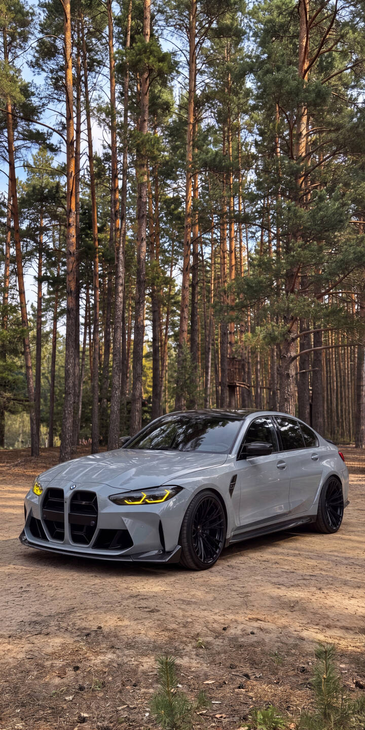 The sleek, light grey BMW M3 with its striking yellow headlights gleams on a rustic dirt path, framed by towering pine trees in this stunning 4K wallpaper. This captivating automotive wallpaper is perfect for any iPhone, showcasing a luxurious sports car amidst a natural landscape. | car sports car forest iphone bmw wallpaper bmw m3 mobile 4k wallpaper hd wallpaper automotive grey car The sleek, light grey BMW M3 with its striking yellow headlights gleams on a rustic dirt path, framed by towering pine trees in this stunning 4K wallpaper. This captivating automotive wallpaper is perfect for any iPhone, showcasing a luxurious sports car amidst a natural landscape.