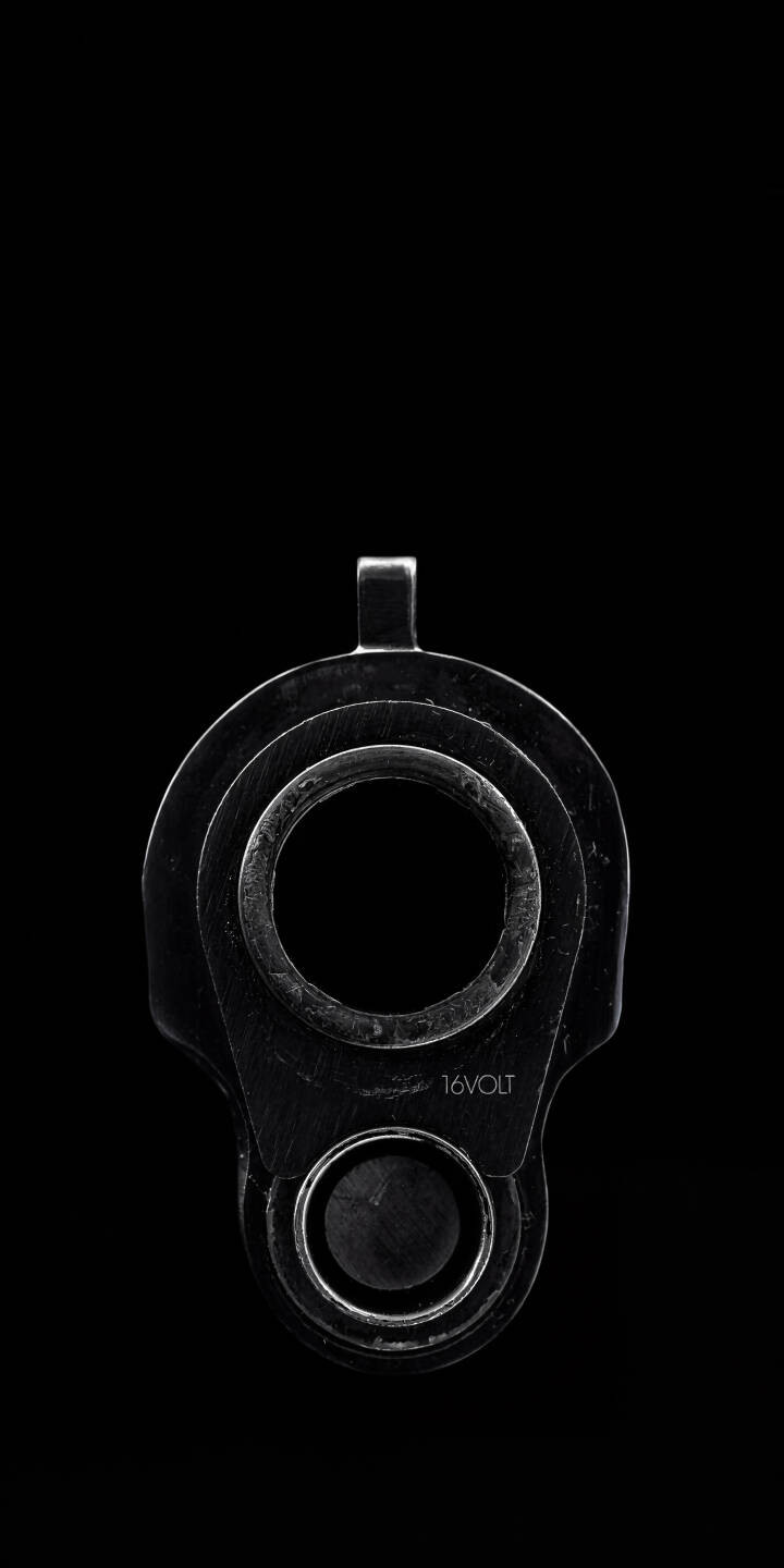 The gleaming metallic texture of a pistol muzzle confronts the viewer in this dark 4K wallpaper, featuring the subtle '16VOLT' inscription on a stark black background. It's an intense and minimalist wallpaper perfect for your iPhone. | black dark iphone minimalist wallpaper pistol mobile metallic 4k wallpaper hd wallpaper firearm gun barrel The gleaming metallic texture of a pistol muzzle confronts the viewer in this dark 4K wallpaper, featuring the subtle '16VOLT' inscription on a stark black background. It's an intense and minimalist wallpaper perfect for your iPhone.