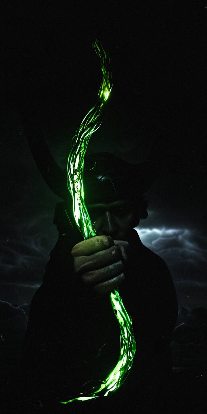 The menacing green glow of Loki's scepter pierces through the darkness as the God of Mischief gazes intently in this dark 4K wallpaper, making an epic wallpaper for iPhone screens. | aesthetic dark marvel magic iphone wallpaper mobile 4k wallpaper hd wallpaper loki god of mischief green scepter The menacing green glow of Loki's scepter pierces through the darkness as the God of Mischief gazes intently in this dark 4K wallpaper, making an epic wallpaper for iPhone screens.