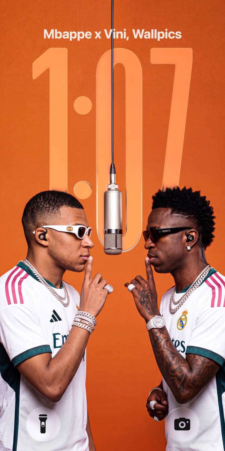 A vibrant orange background highlights Mbappé and Vinicius Jr. making a silent 'shhh' gesture, adorned in their crisp white Real Madrid jerseys and dazzling diamond chains; this striking 4K wallpaper offers an iconic duo wallpaper for your iPhone. | iphone mbappe soccer real madrid stylish wallpaper vinicius jr mobile celebrity 4k wallpaper hd wallpaper shhh gesture A vibrant orange background highlights Mbappé and Vinicius Jr. making a silent 'shhh' gesture, adorned in their crisp white Real Madrid jerseys and dazzling diamond chains; this striking 4K wallpaper offers an iconic duo wallpaper for your iPhone.