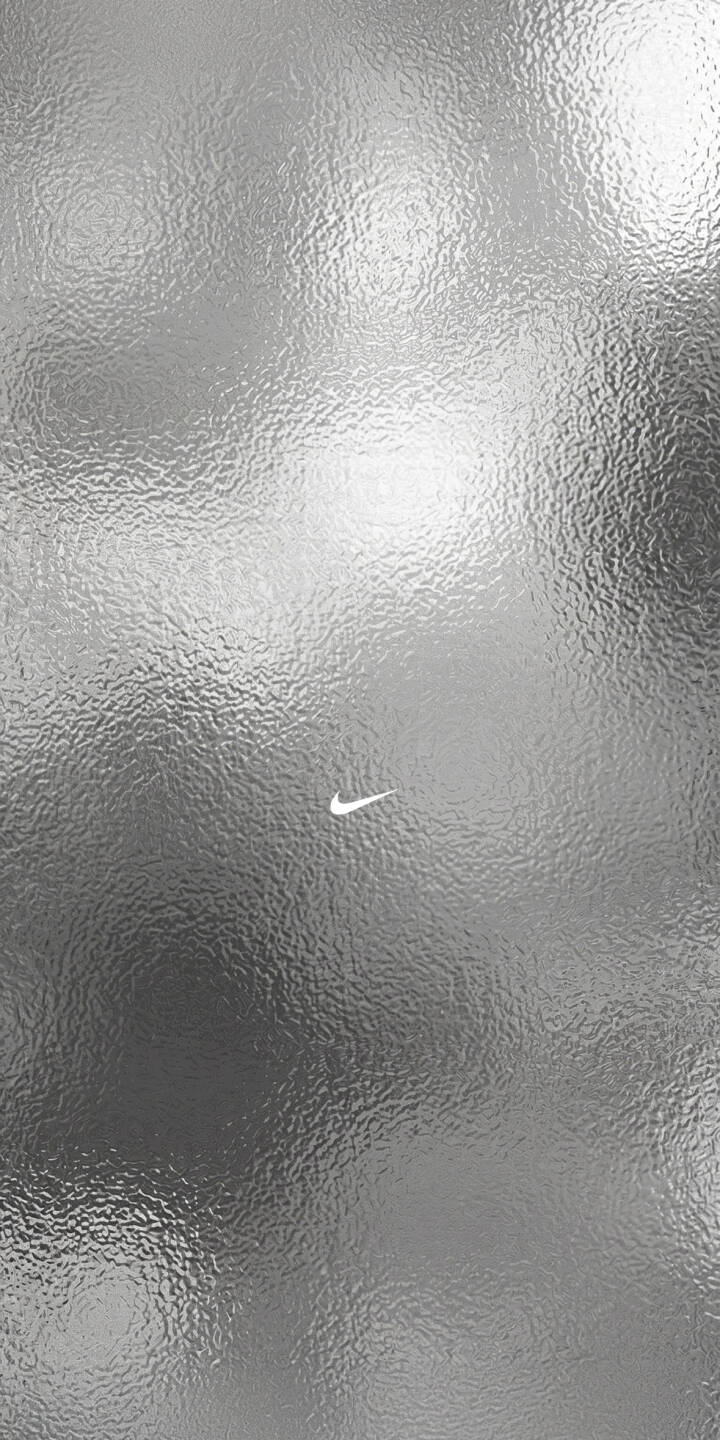 The shimmering silver texture with its intricate wrinkles creates a dynamic metallic effect around the iconic white Nike swoosh in this stunning 4K wallpaper. This abstract background makes a sleek, modern wallpaper for iPhone users. | aesthetic silver nike iphone minimalist wallpaper texture mobile metallic 4k wallpaper hd wallpaper nike logo The shimmering silver texture with its intricate wrinkles creates a dynamic metallic effect around the iconic white Nike swoosh in this stunning 4K wallpaper. This abstract background makes a sleek, modern wallpaper for iPhone users.