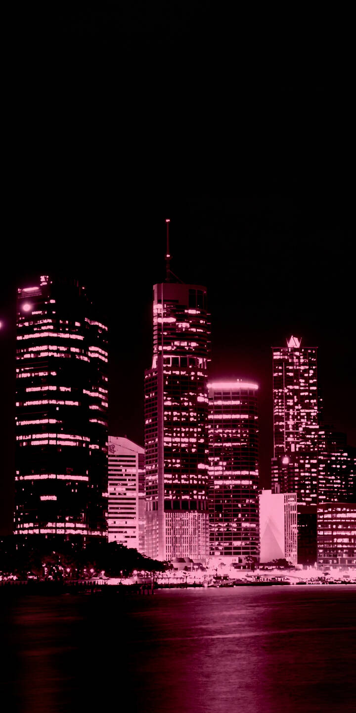 A captivating pink and magenta glow illuminates a modern city skyline, with towering skyscrapers casting stunning reflections across the dark water in this vibrant 4K wallpaper. This atmospheric wallpaper is perfect for any iPhone, adding a touch of urban neon to your screen. | pink aesthetic city night neon skyline iphone wallpaper mobile 4k wallpaper hd wallpaper cityscape A captivating pink and magenta glow illuminates a modern city skyline, with towering skyscrapers casting stunning reflections across the dark water in this vibrant 4K wallpaper. This atmospheric wallpaper is perfect for any iPhone, adding a touch of urban neon to your screen.
