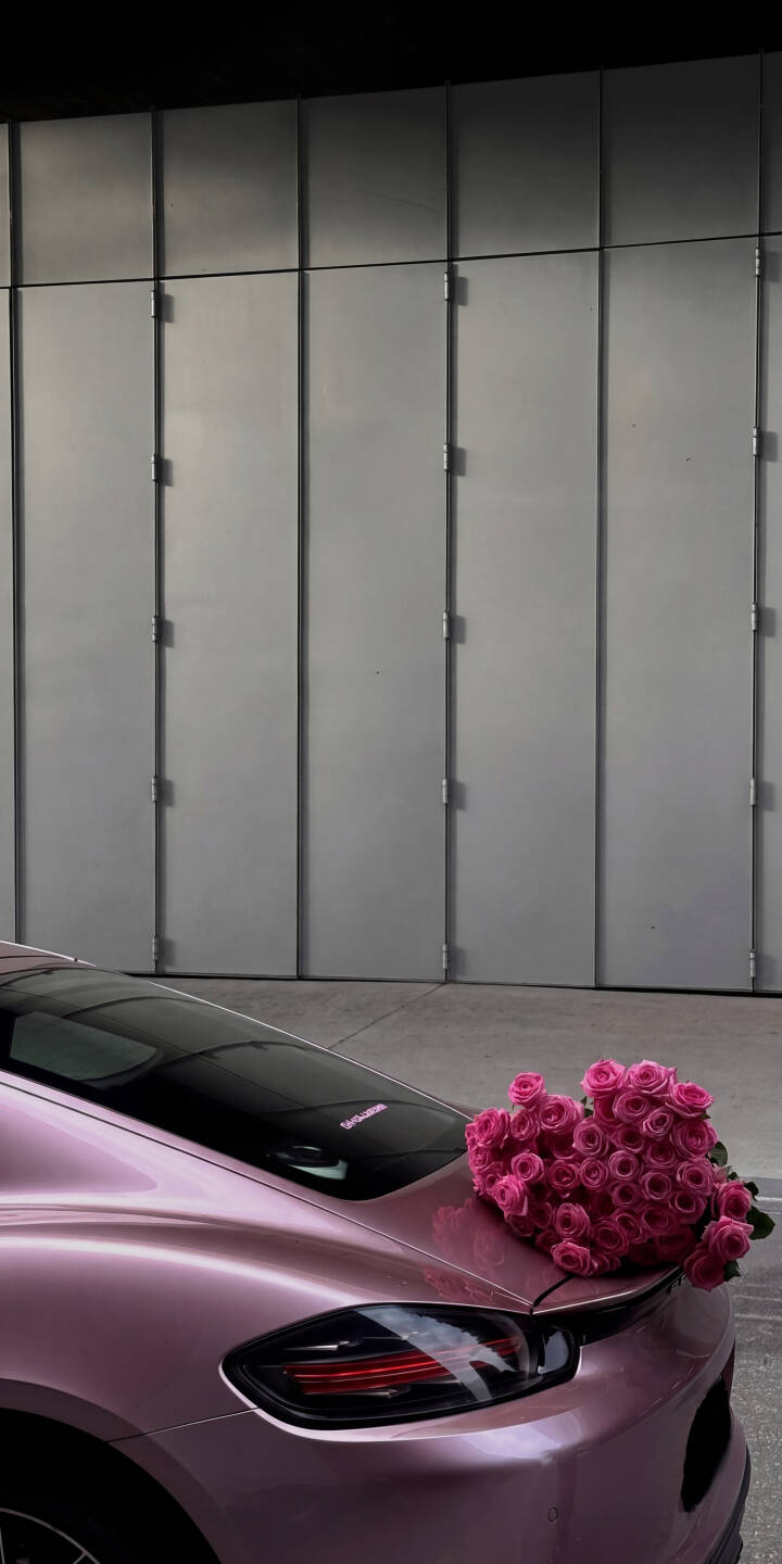 A gorgeous heart-shaped bouquet of vibrant pink roses rests elegantly on the sleek rear of a glossy pink sports car, creating a stunning 4K wallpaper that captures luxury and romance. This beautiful wallpaper is perfect for any iPhone, adding a touch of glamour to your mobile screen. | aesthetic sports car iphone wallpaper mobile luxury car romantic pink car roses 4k wallpaper hd wallpaper heart roses A gorgeous heart-shaped bouquet of vibrant pink roses rests elegantly on the sleek rear of a glossy pink sports car, creating a stunning 4K wallpaper that captures luxury and romance. This beautiful wallpaper is perfect for any iPhone, adding a touch of glamour to your mobile screen.