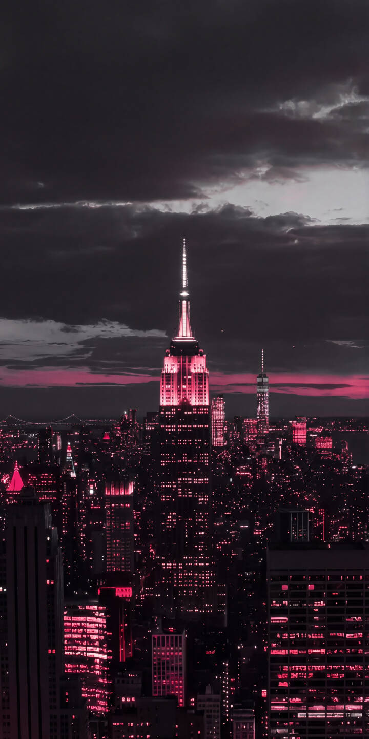 The iconic Empire State Building glows in a striking pink hue against a dramatic cloudy night sky, illuminating a vast cityscape in this mesmerizing 4K wallpaper. This unique wallpaper is perfect for personalizing your iPhone. | pink aesthetic urban night empire state building iphone wallpaper mobile new york city nyc 4k wallpaper hd wallpaper The iconic Empire State Building glows in a striking pink hue against a dramatic cloudy night sky, illuminating a vast cityscape in this mesmerizing 4K wallpaper. This unique wallpaper is perfect for personalizing your iPhone.