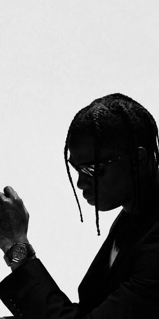 A striking high-contrast black and white portrait captures Travis Scott's iconic profile, showcasing his braided hair and dark sunglasses. This moody 4K wallpaper is a must-have for iPhone users seeking an aesthetic wallpaper of the artist. | artist A striking high-contrast black and white portrait captures Travis Scott's iconic profile, showcasing his braided hair and dark sunglasses. This moody 4K wallpaper is a must-have for iPhone users seeking an aesthetic wallpaper of the artist.