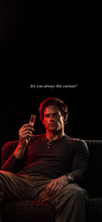 Bathed in a menacing red light, Dexter Morgan intensely holds a blood slide in this gripping 4K wallpaper. This image, along with its counterpart, forms a perfect matching wallpaper for two iPhone screens, capturing Dexter's dark essence as he asks, "Are you always this curious?".