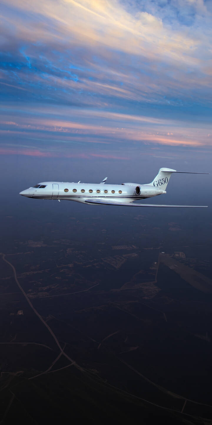 An elegant white Gulfstream G650 jet soars through a breathtaking twilight sky painted with hues of pink, blue, and gold in this stunning 4K wallpaper, making it a perfect iPhone wallpaper for aviation enthusiasts. | sunset sky iphone private jet wallpaper mobile 4k wallpaper hd wallpaper aviation gulfstream gulfstream g650 luxury jet An elegant white Gulfstream G650 jet soars through a breathtaking twilight sky painted with hues of pink, blue, and gold in this stunning 4K wallpaper, making it a perfect iPhone wallpaper for aviation enthusiasts.