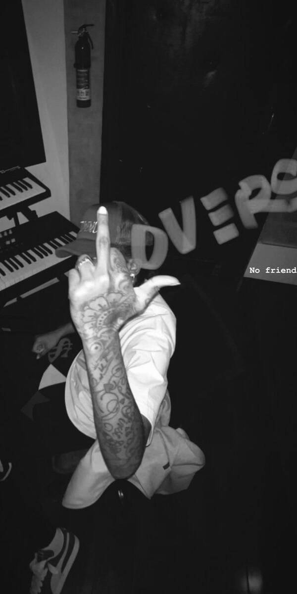A defiant middle finger, adorned with intricate tattoos, dominates this striking black and white 4K wallpaper, perfect for iPhone users. This edgy wallpaper captures a raw, rebellious mood with a music keyboard and faint text in the background. | artist A defiant middle finger, adorned with intricate tattoos, dominates this striking black and white 4K wallpaper, perfect for iPhone users. This edgy wallpaper captures a raw, rebellious mood with a music keyboard and faint text in the background.