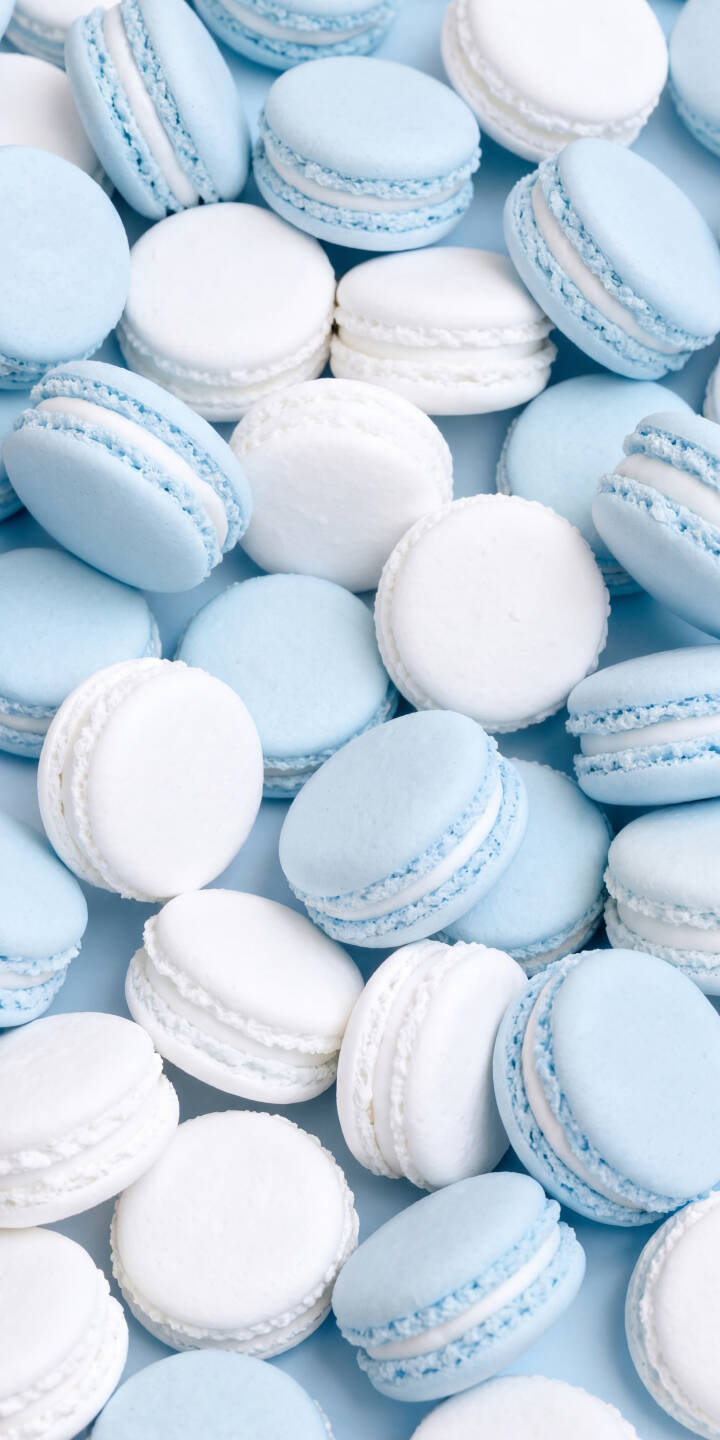 A delightful mix of soft blue and pristine white macarons are artfully scattered across a pastel background in this charming 4K wallpaper, creating an irresistibly sweet wallpaper for iPhone. | aesthetic blue white iphone wallpaper pastel sweet mobile dessert 4k wallpaper hd wallpaper macarons A delightful mix of soft blue and pristine white macarons are artfully scattered across a pastel background in this charming 4K wallpaper, creating an irresistibly sweet wallpaper for iPhone.