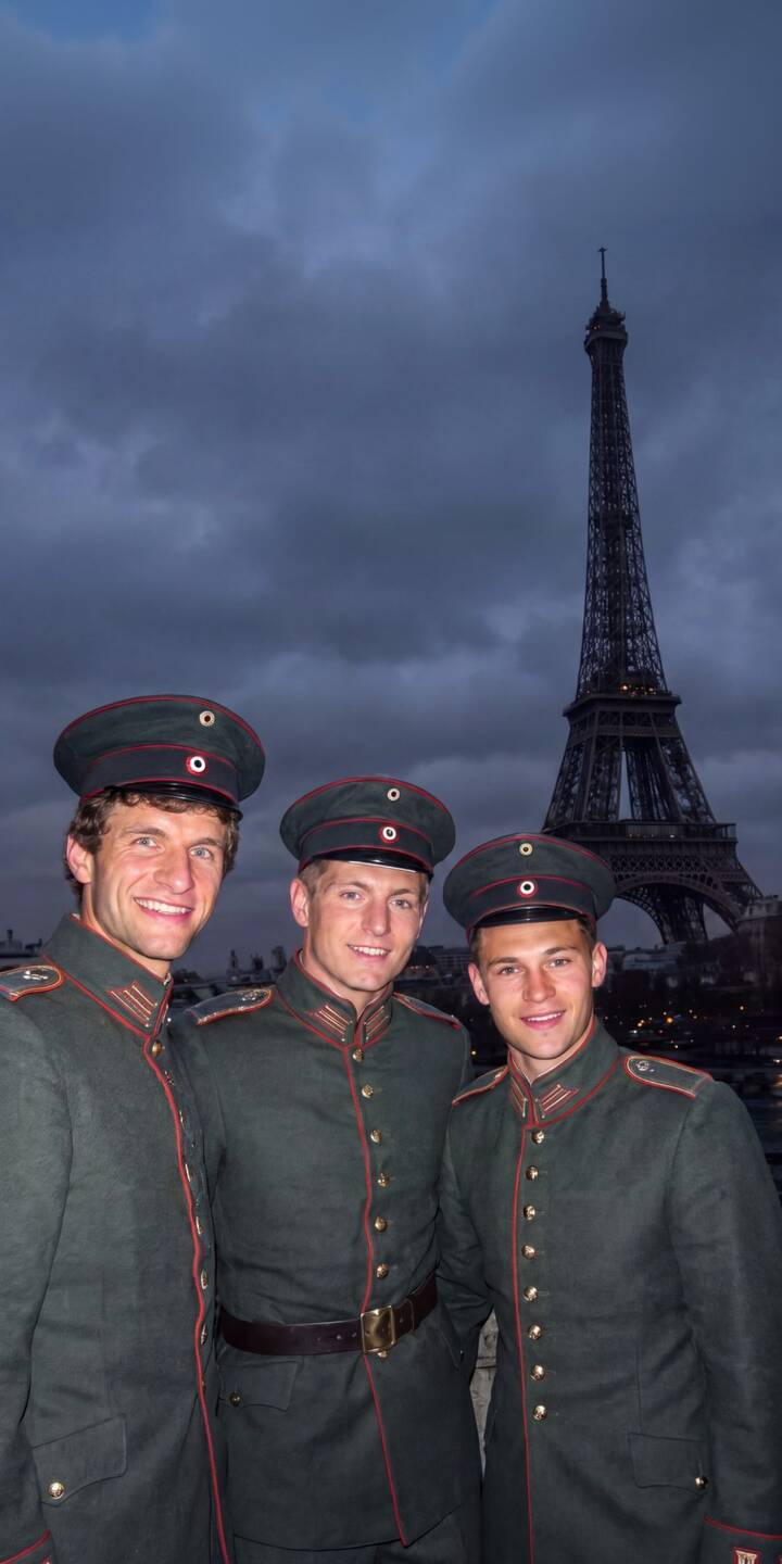 Striking green military-style uniforms with red piping are worn by German football stars Thomas Müller, Toni Kroos, and Mario Götze, who smile brightly against the backdrop of the iconic Eiffel Tower in this unique 4K wallpaper. This charming scene offers a memorable wallpaper for iPhone, capturing a fun moment in Paris. | iphone paris wallpaper mobile toni kroos military uniform 4k wallpaper hd wallpaper german football eiffel tower thomas muller mario gotze Striking green military-style uniforms with red piping are worn by German football stars Thomas Müller, Toni Kroos, and Mario Götze, who smile brightly against the backdrop of the iconic Eiffel Tower in this unique 4K wallpaper. This charming scene offers a memorable wallpaper for iPhone, capturing a fun moment in Paris.