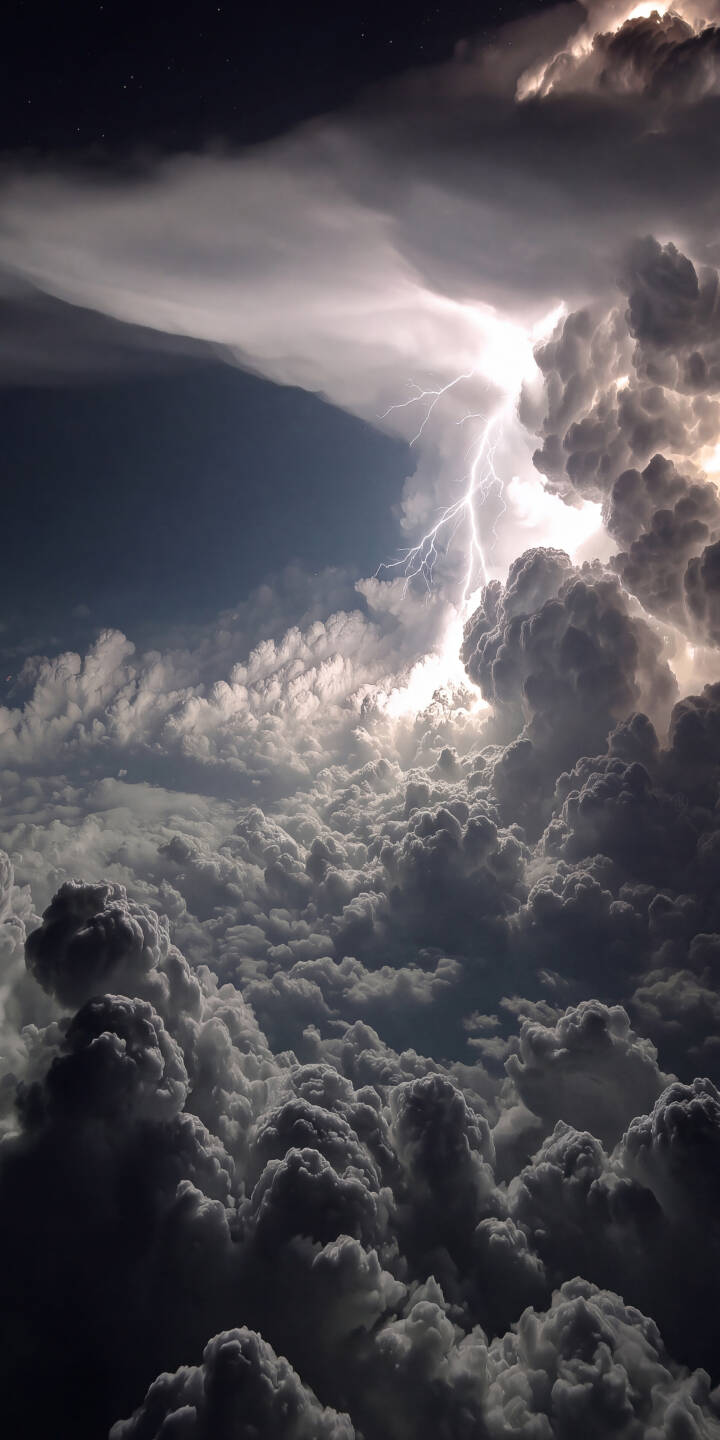 A jagged bolt of lightning brilliantly illuminates dark swirling clouds in this powerful 4K storm wallpaper, a breathtaking natural phenomenon wallpaper perfect for your iPhone. | lightning thunderstorm storm iphone nature clouds wallpaper mobile 4k wallpaper hd wallpaper weather epic A jagged bolt of lightning brilliantly illuminates dark swirling clouds in this powerful 4K storm wallpaper, a breathtaking natural phenomenon wallpaper perfect for your iPhone.