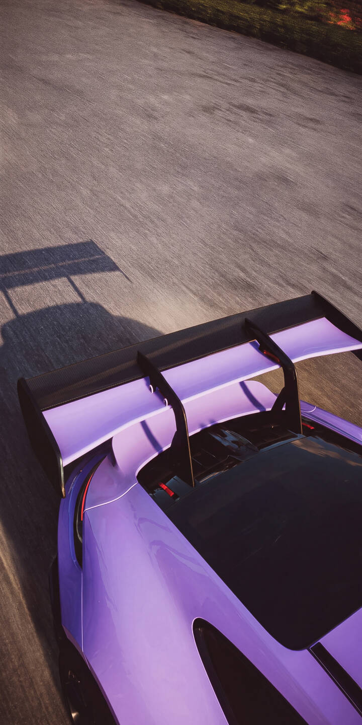 The striking vibrant purple finish of this Porsche's prominent rear wing cuts a sleek profile against the asphalt, casting a long shadow in this dynamic 4K wallpaper. This stunning car wallpaper is perfect for any iPhone to elevate your screen with high-speed style. | sports car wing purple road iphone porsche gt3 wallpaper mobile 4k wallpaper hd wallpaper automotive The striking vibrant purple finish of this Porsche's prominent rear wing cuts a sleek profile against the asphalt, casting a long shadow in this dynamic 4K wallpaper. This stunning car wallpaper is perfect for any iPhone to elevate your screen with high-speed style.