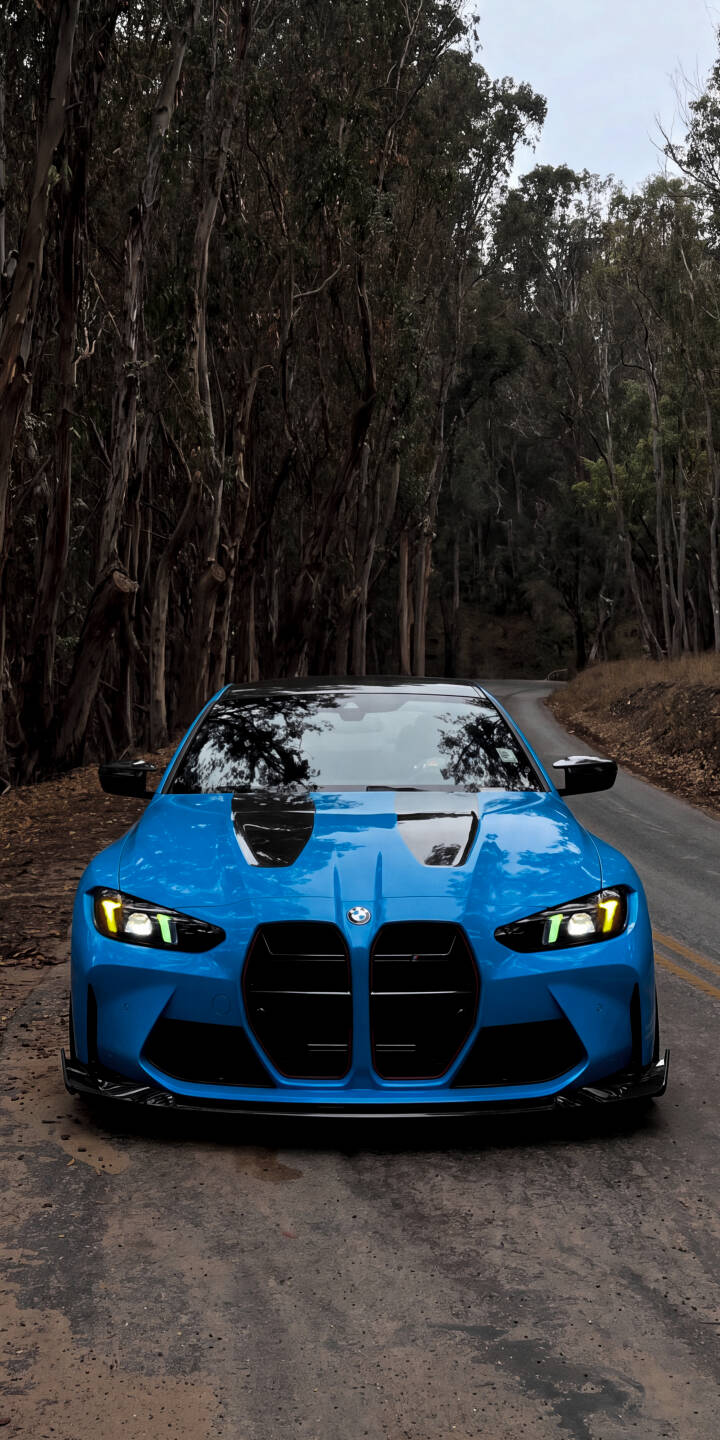 The brilliant blue BMW M4 sits majestically on a winding forest road, its distinct headlights glowing brightly in this stunning 4K wallpaper. This dynamic car wallpaper captures the vehicle's powerful presence, making it an ideal choice for your iPhone. | sports car iphone bmw wallpaper bmw m4 mobile blue car 4k wallpaper hd wallpaper automotive m4 g82 forest road The brilliant blue BMW M4 sits majestically on a winding forest road, its distinct headlights glowing brightly in this stunning 4K wallpaper. This dynamic car wallpaper captures the vehicle's powerful presence, making it an ideal choice for your iPhone.