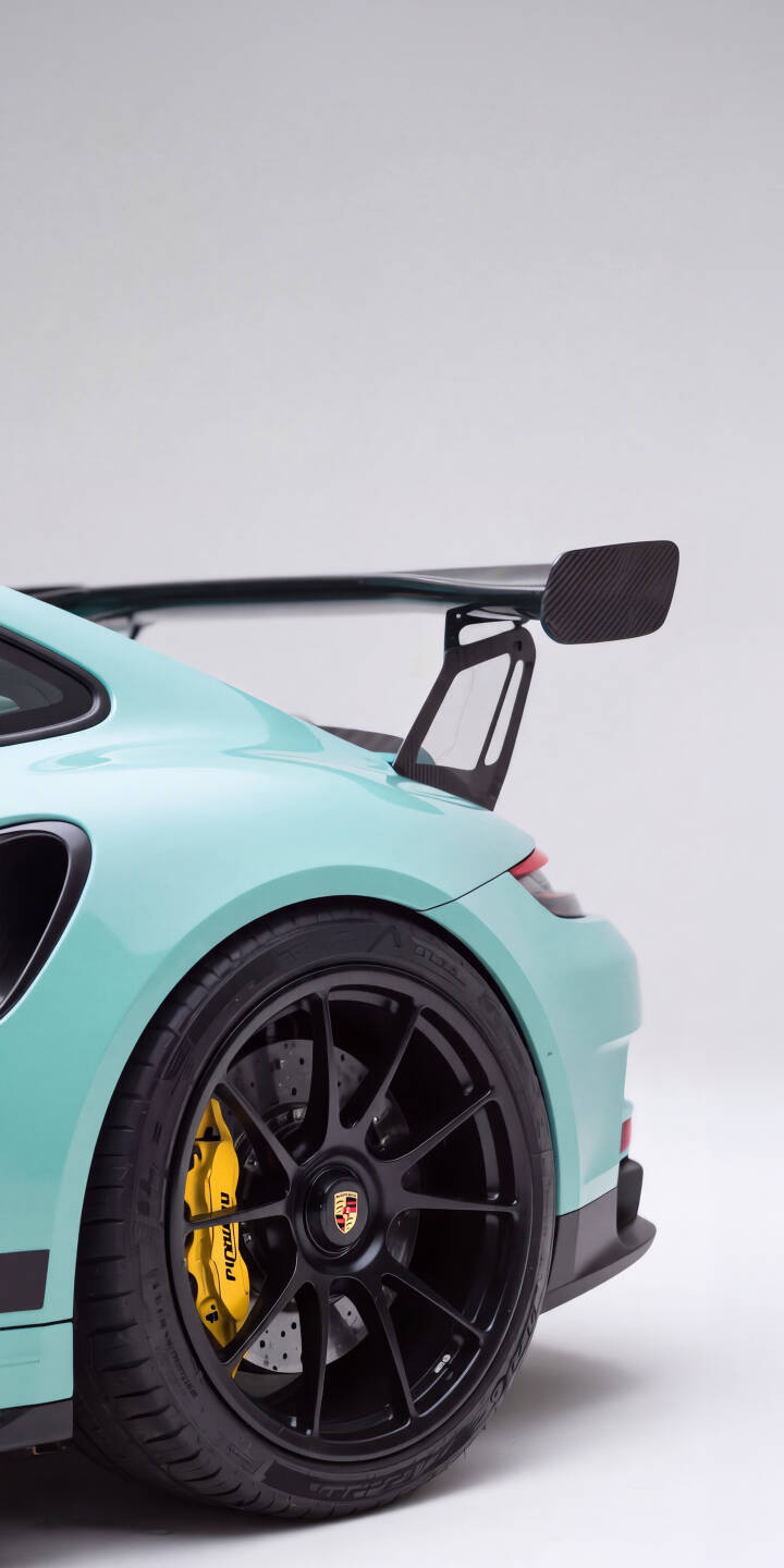 The striking teal paint of the Porsche GT3 RS gleams, showcasing its powerful carbon fiber wing and vibrant yellow brake calipers in this exquisite 4K wallpaper. This dynamic rear-angle automotive wallpaper is perfect for any iPhone, highlighting the iconic sports car's sleek design. | sports car teal iphone porsche supercar wallpaper mobile gt3 rs carbon fiber 4k wallpaper hd wallpaper automotive The striking teal paint of the Porsche GT3 RS gleams, showcasing its powerful carbon fiber wing and vibrant yellow brake calipers in this exquisite 4K wallpaper. This dynamic rear-angle automotive wallpaper is perfect for any iPhone, highlighting the iconic sports car's sleek design.