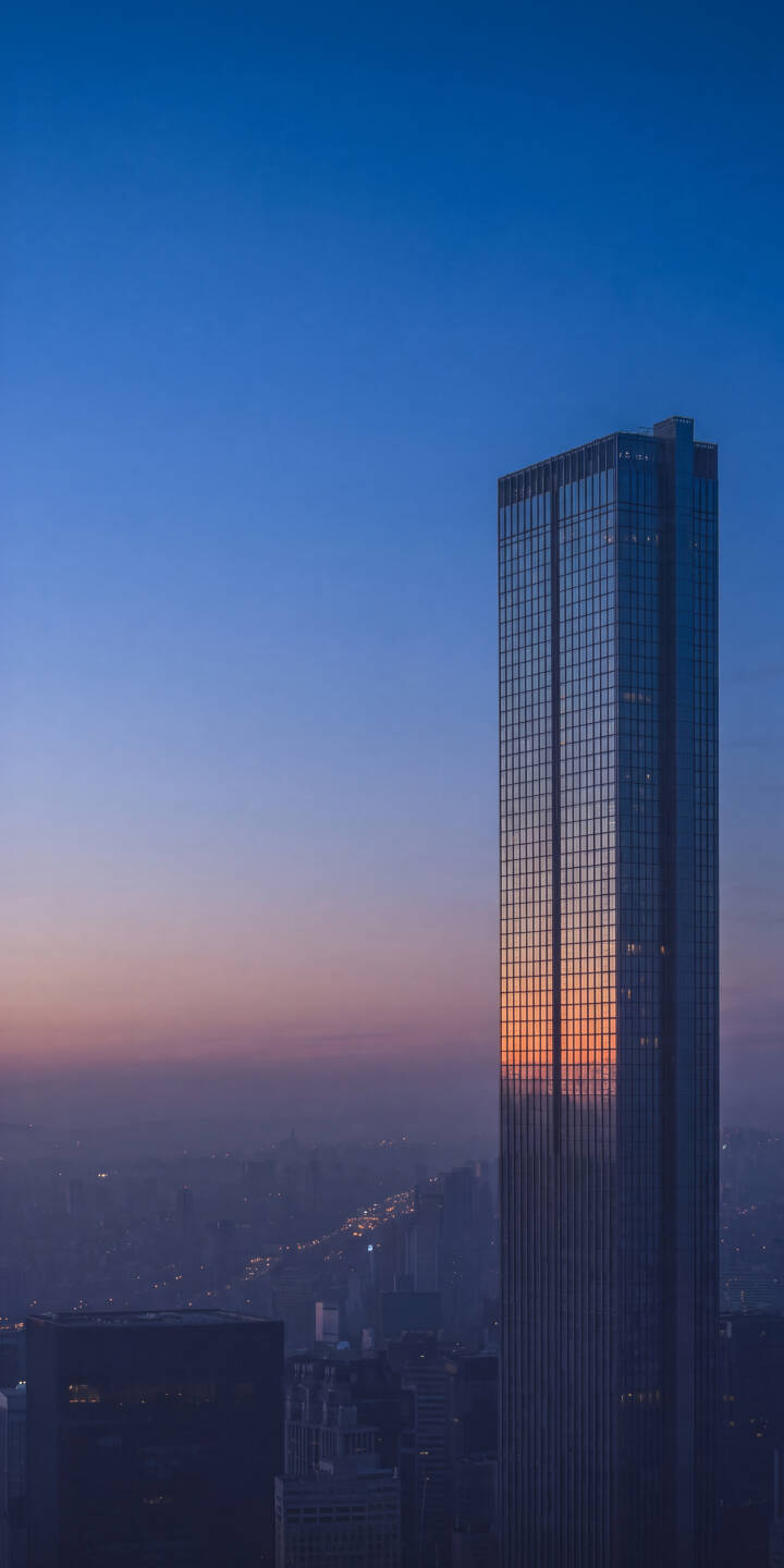 Vibrant orange sunset hues blaze across the reflective glass panels of a towering skyscraper in this stunning 4K wallpaper, making it a perfect urban glow wallpaper for iPhone. | sunset building city urban skyscraper reflection iphone wallpaper modern mobile 4k wallpaper hd wallpaper Vibrant orange sunset hues blaze across the reflective glass panels of a towering skyscraper in this stunning 4K wallpaper, making it a perfect urban glow wallpaper for iPhone.